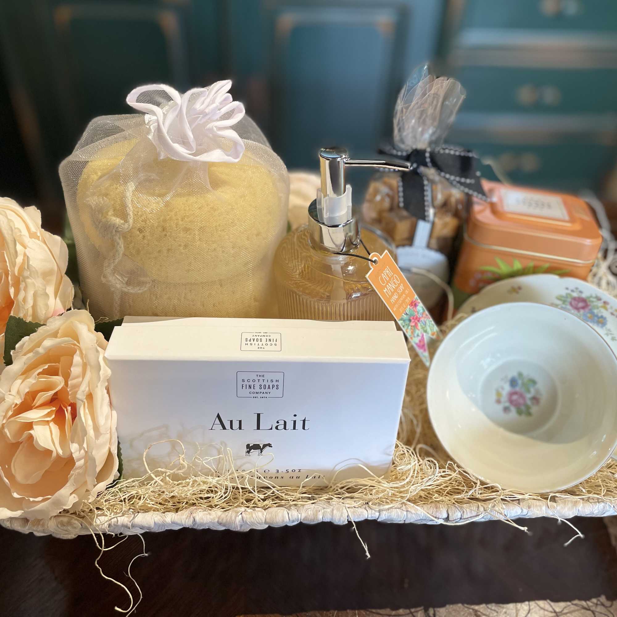 Gift basket with soap, lotion, tea, cups, and peach flowers