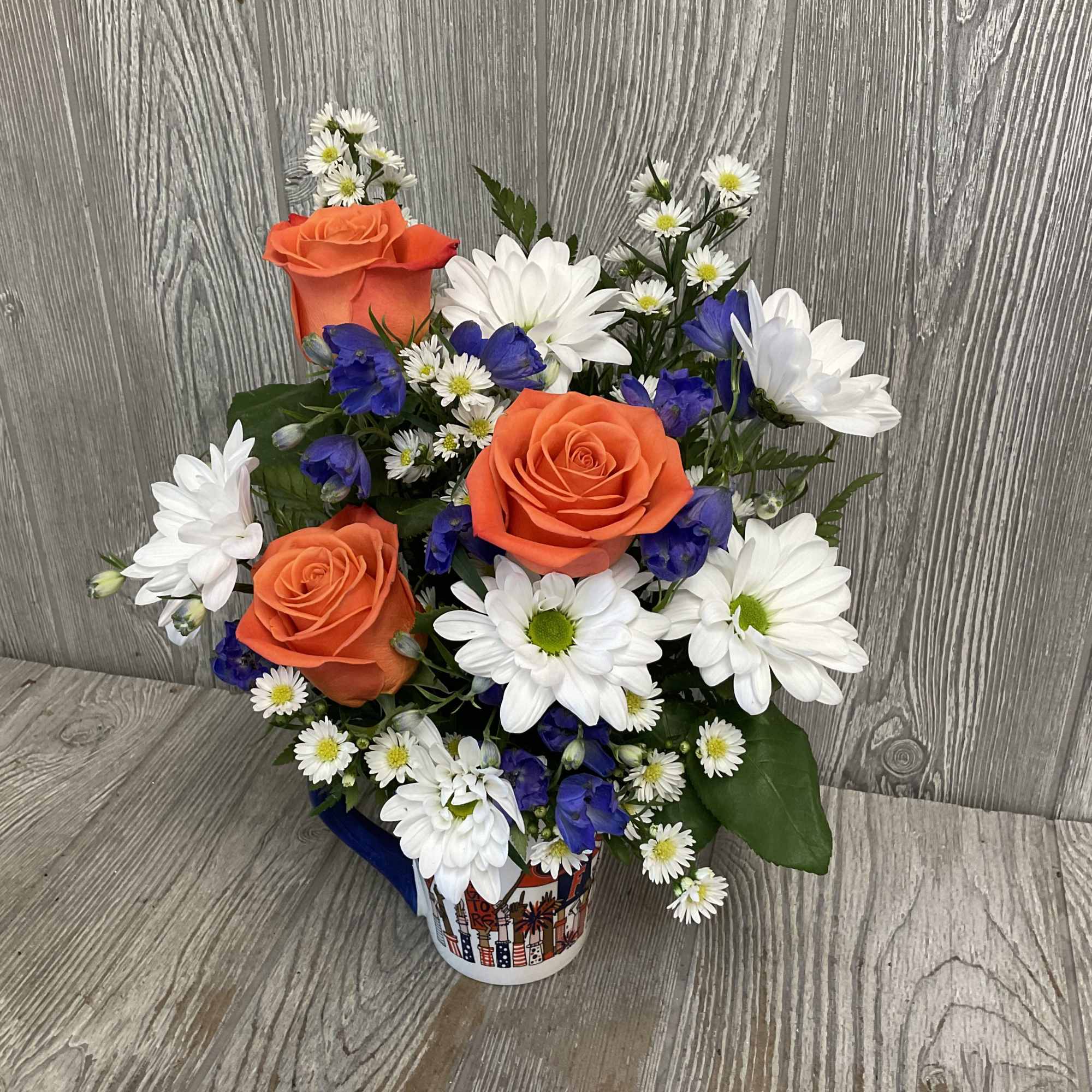 Florida cheer mug with a nice orange and blue flower arrangement. Flowers
