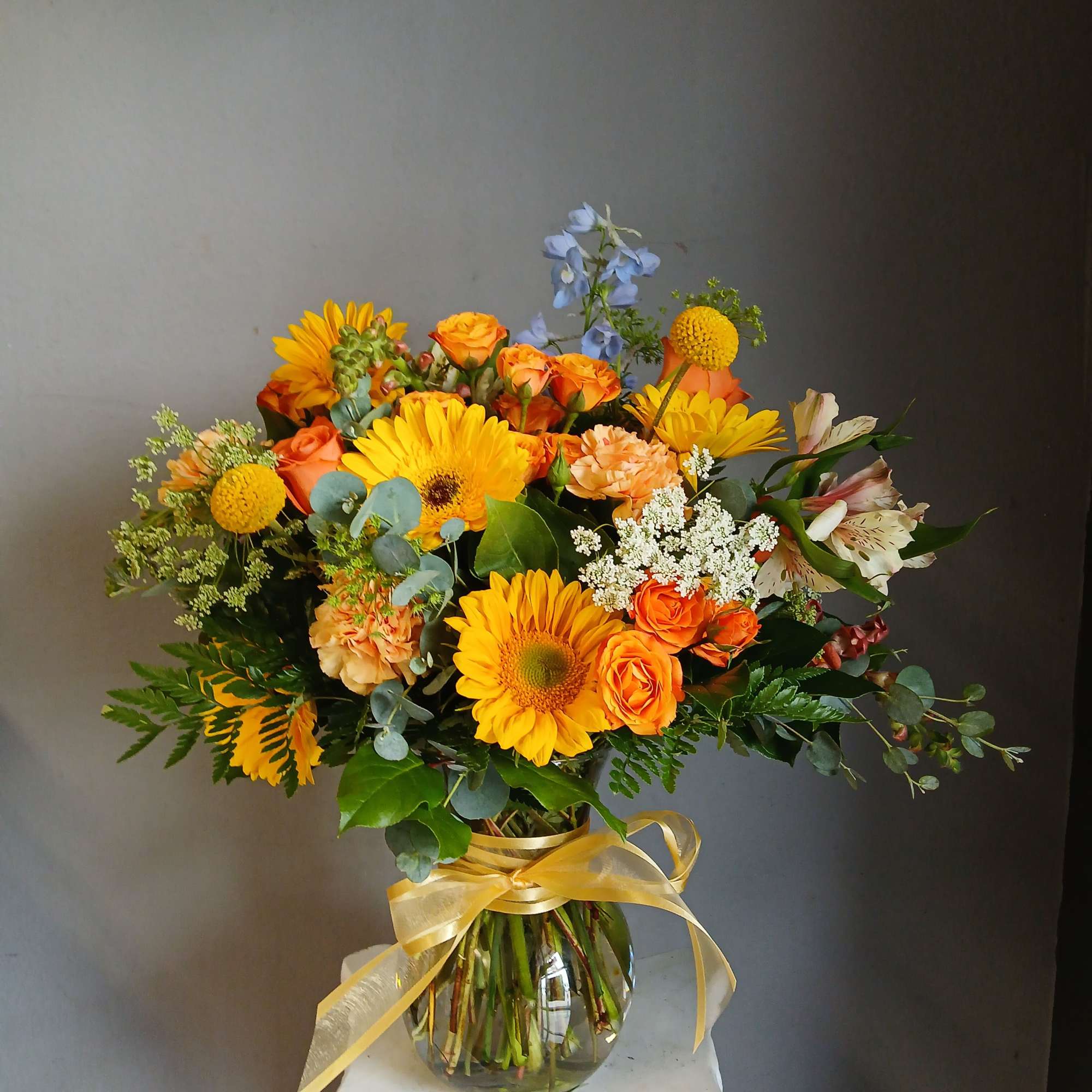 This beautiful flower arrangement of fresh mixed seasonal blooms is made by