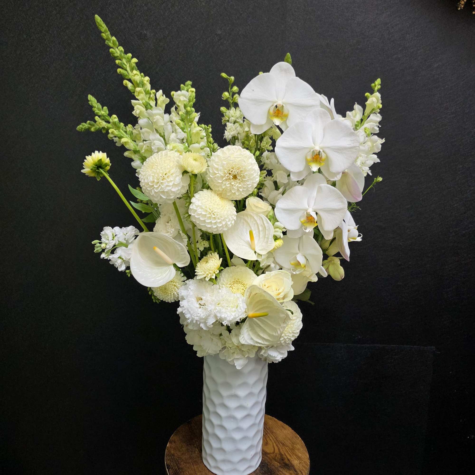 Tall, sculptural white blooms make a serene first impression in this flower
