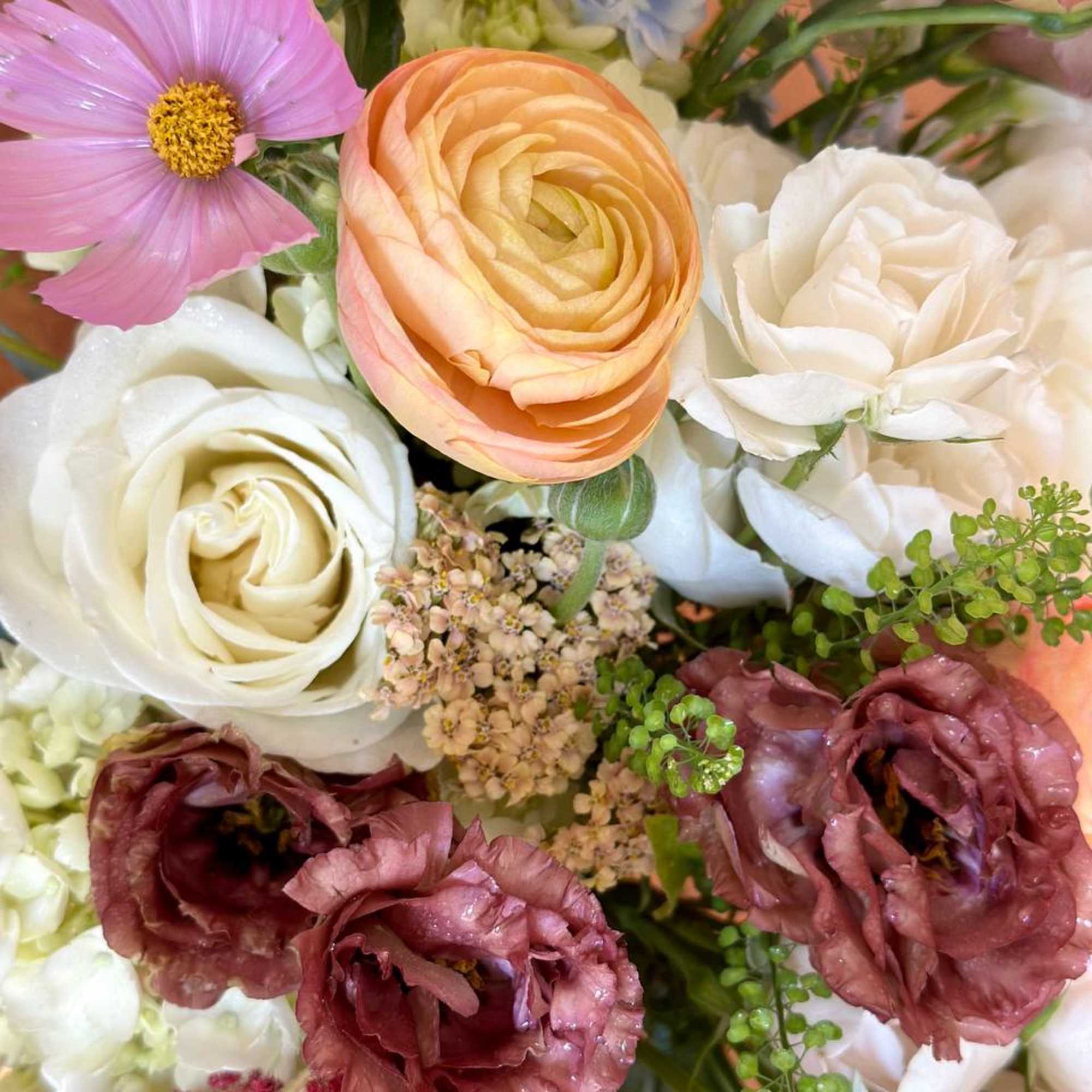 Mixed bouquet with peach, white, pink, and burgundy blooms