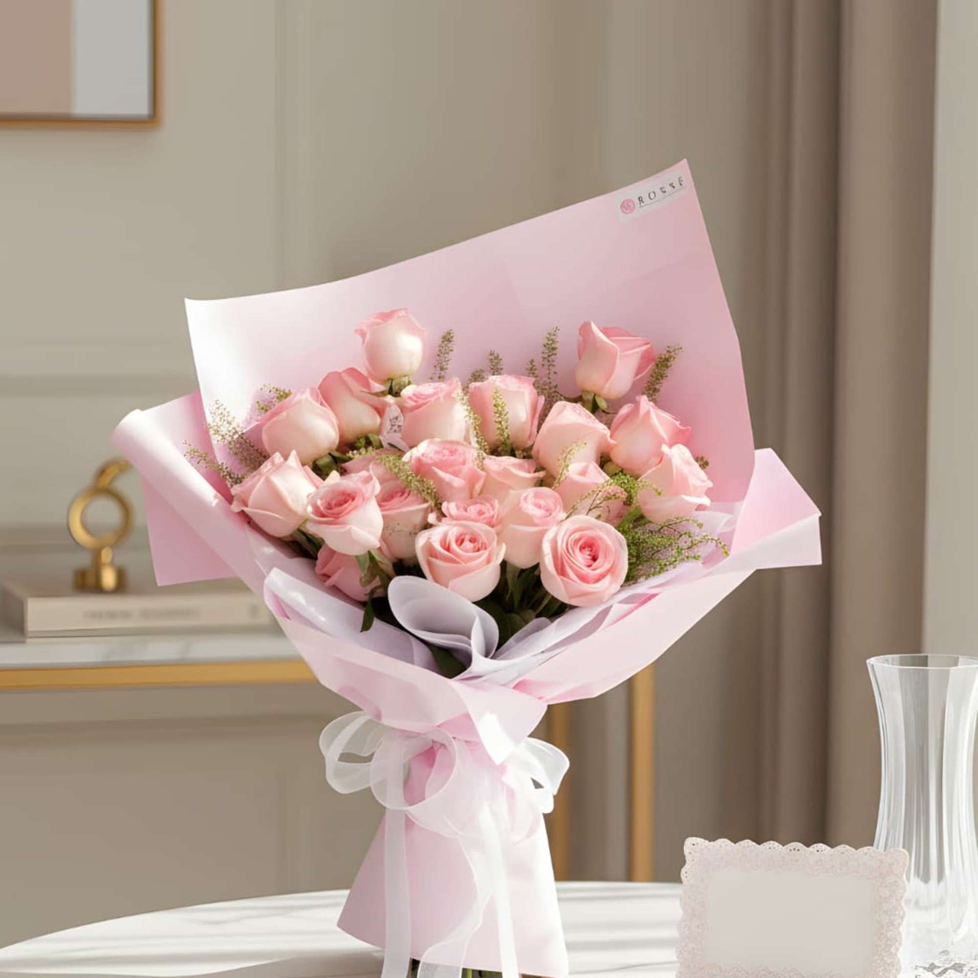 Bouquet of pale pink roses wrapped in pink paper with a white ribbon