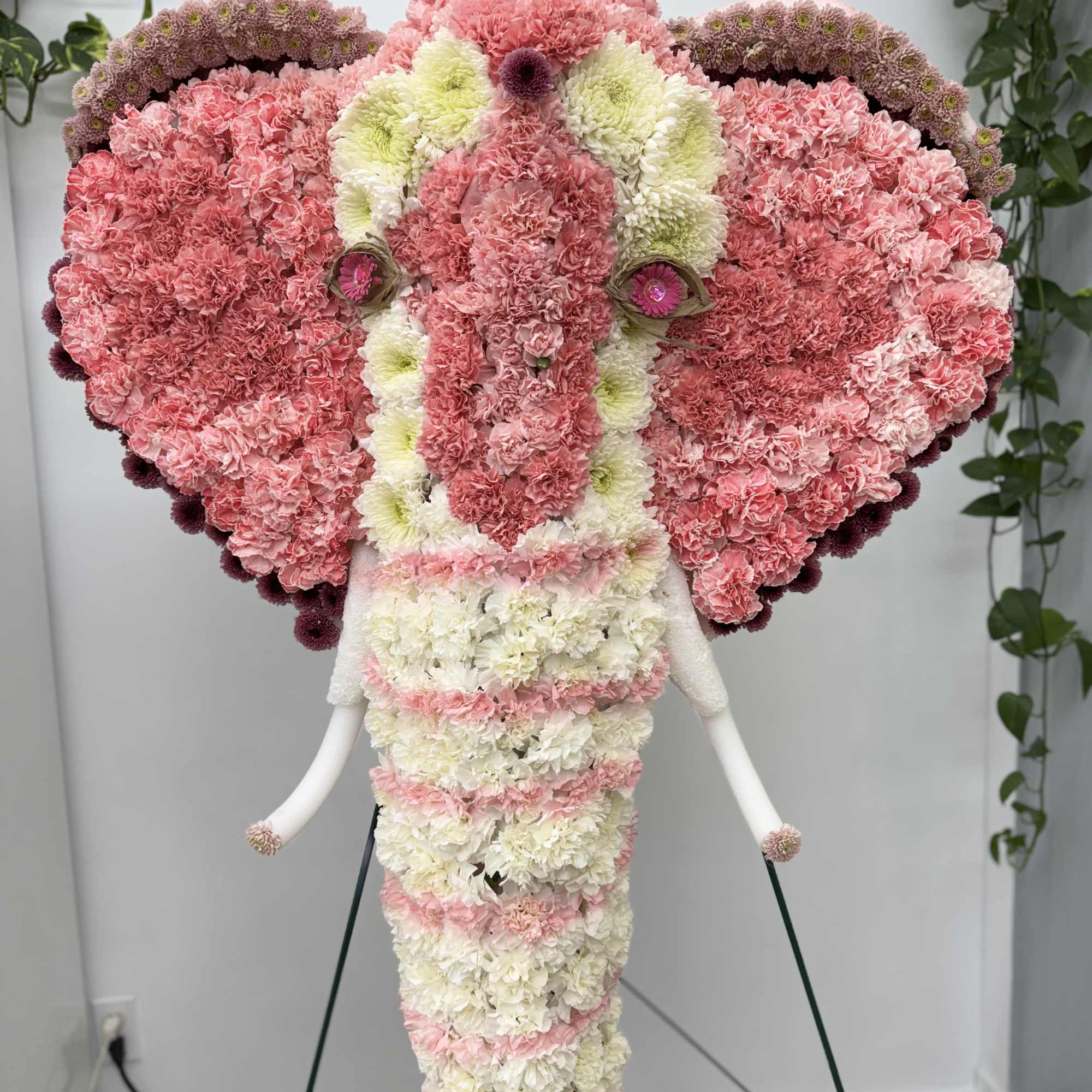 Elephant-shaped floral arrangement in pink and white carnations
