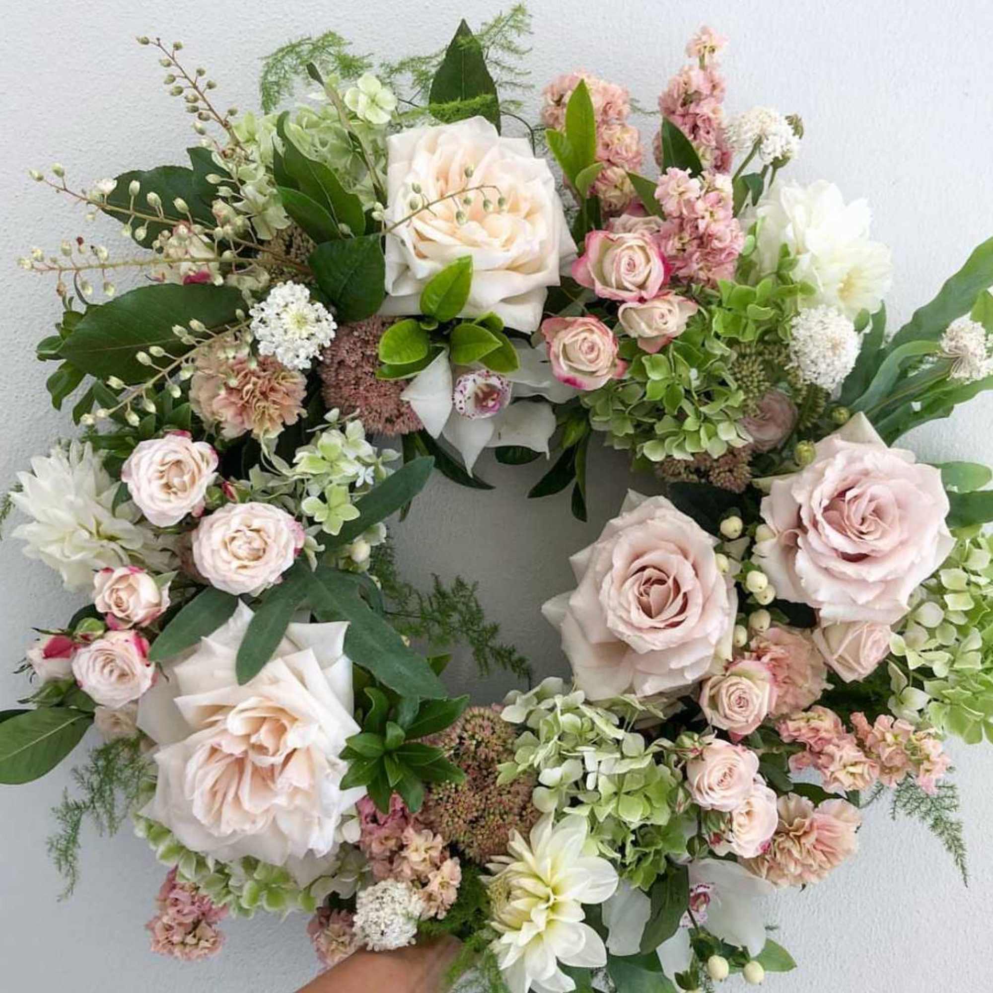 Pastel floral wreath with roses, hydrangeas, and white blooms