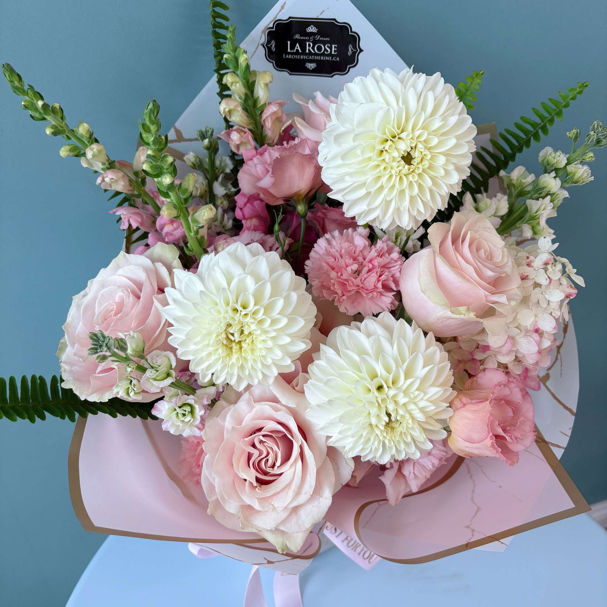 Pink and white bouquet with roses, dahlias, and snapdragons