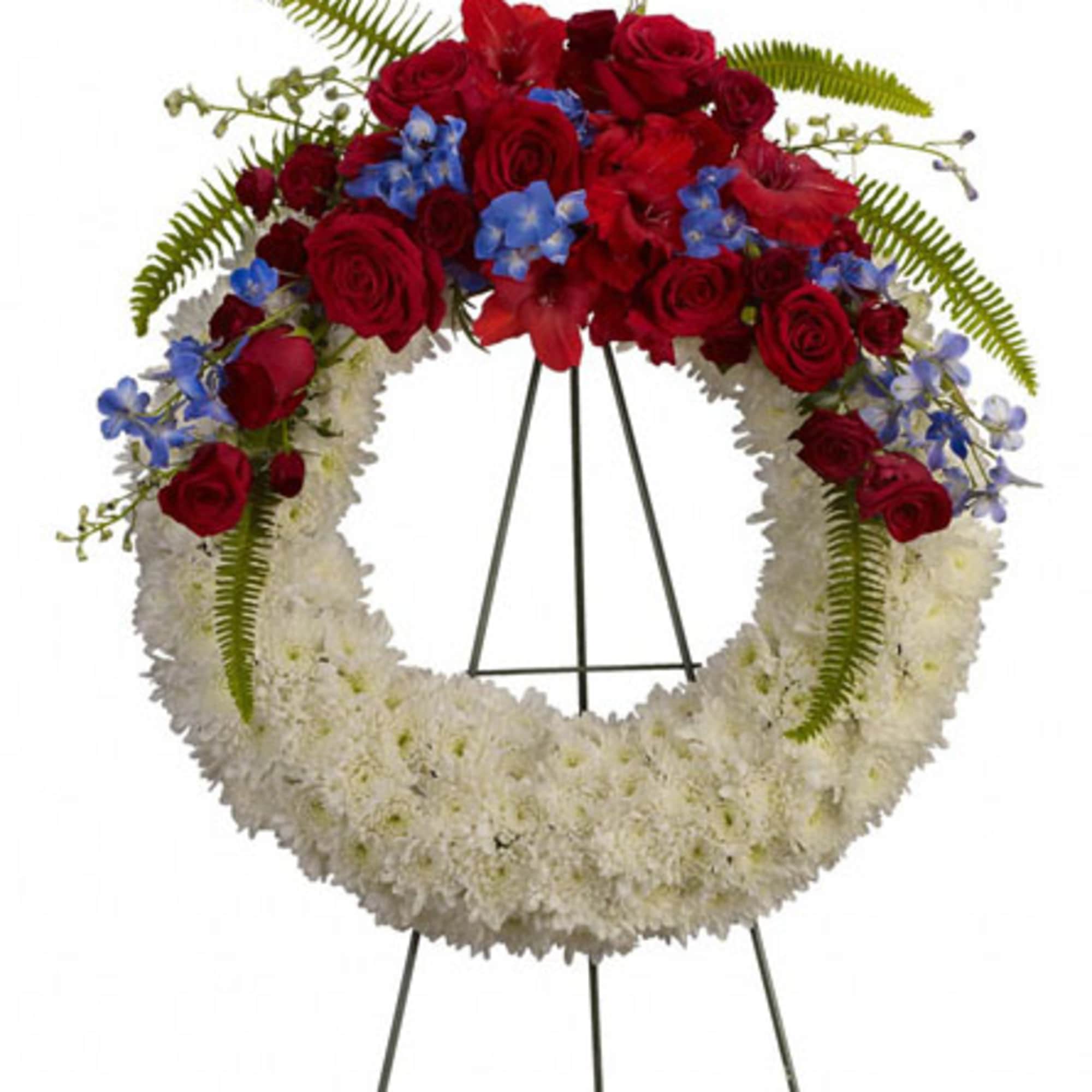 Red and white floral wreath on a black stand