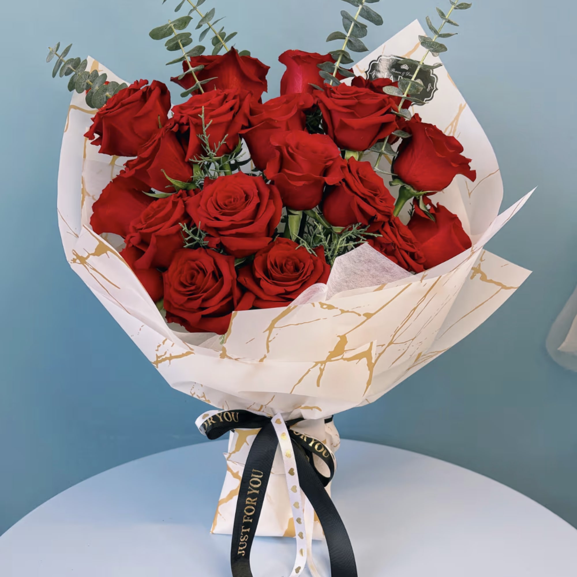 Indulge in the elegance of premium roses, beautifully arranged with complementary floral