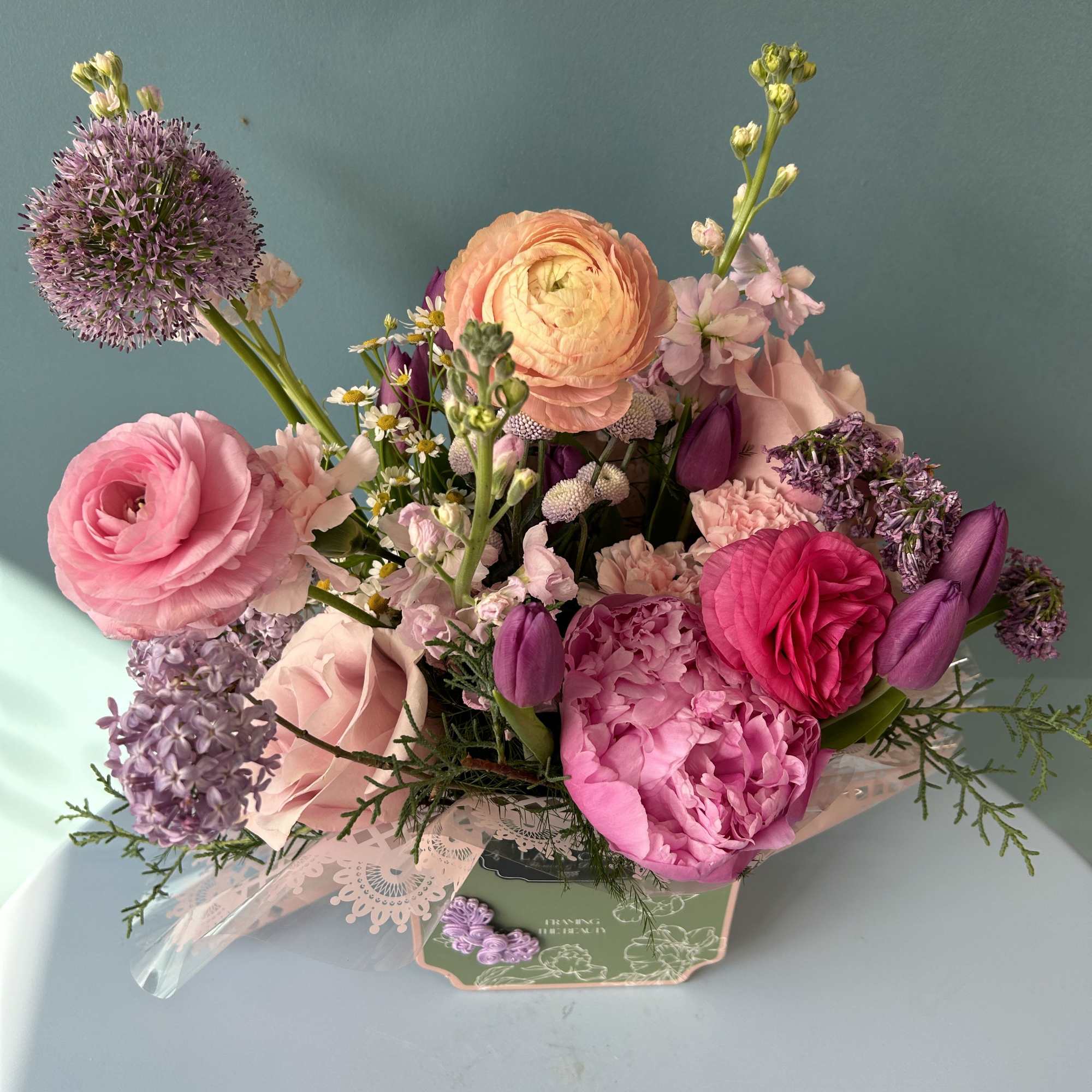 Pink and purple mixed bouquet in a decorative box