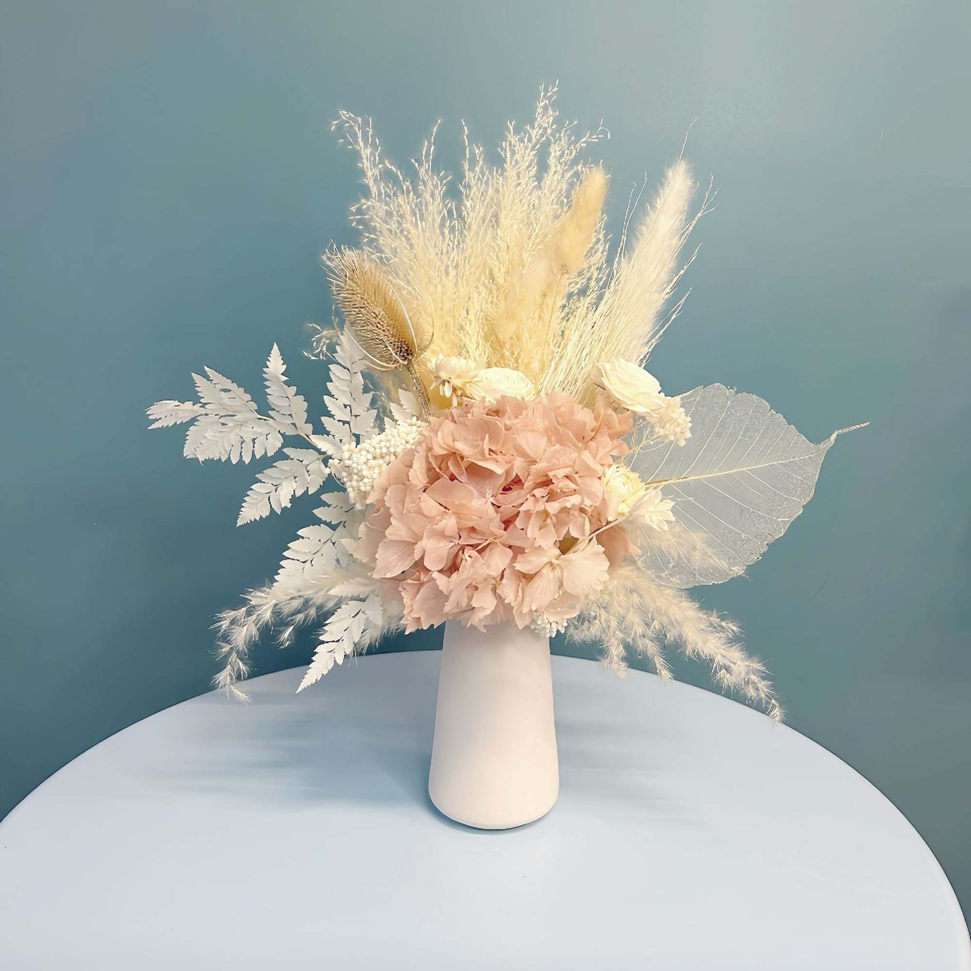 Blush dried flower arrangement in a white vase