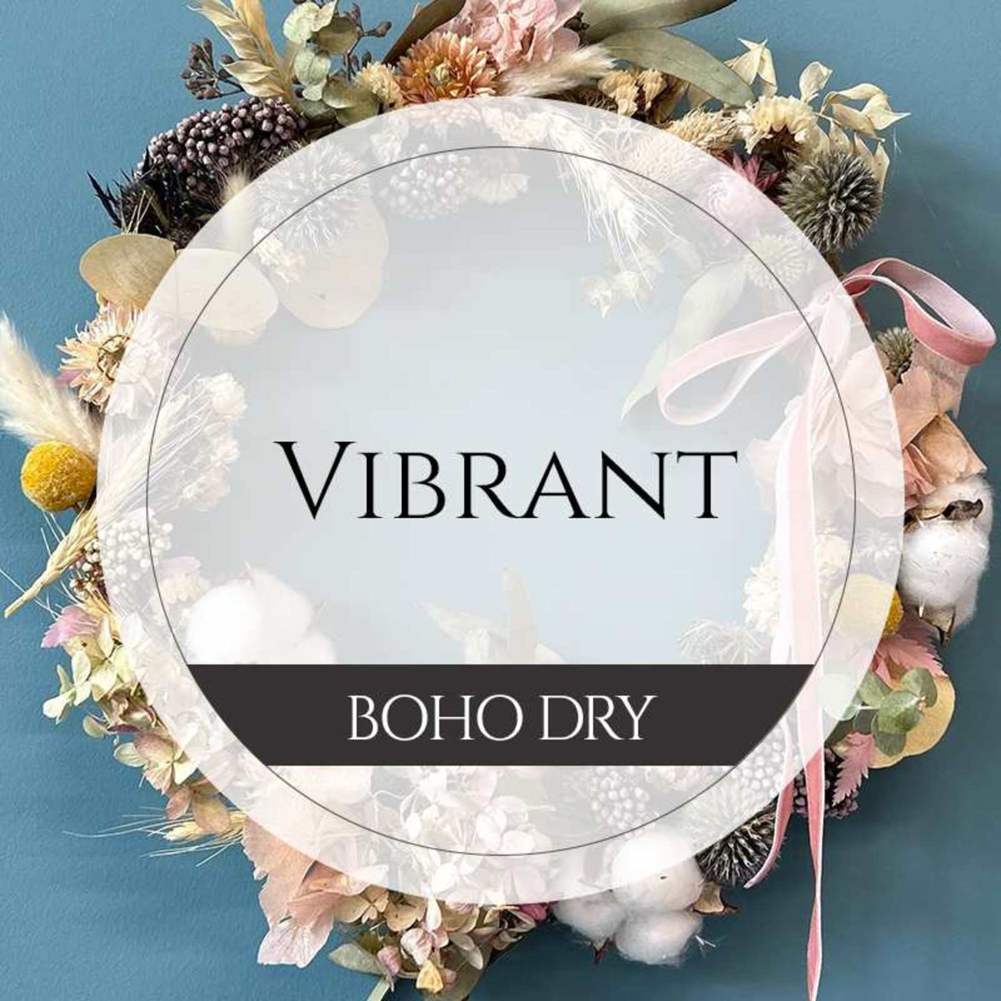 Boho dried floral wreath with pastel blooms and ribbon on a blue background