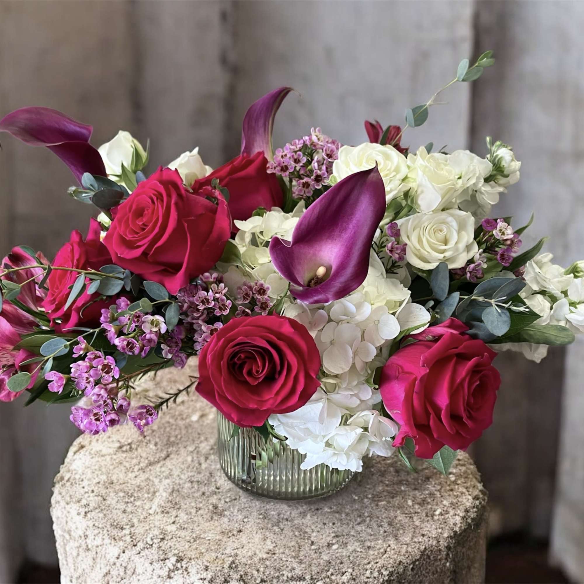 A lush and elegant arrangement featuring soft white hydrangeas paired with vibrant