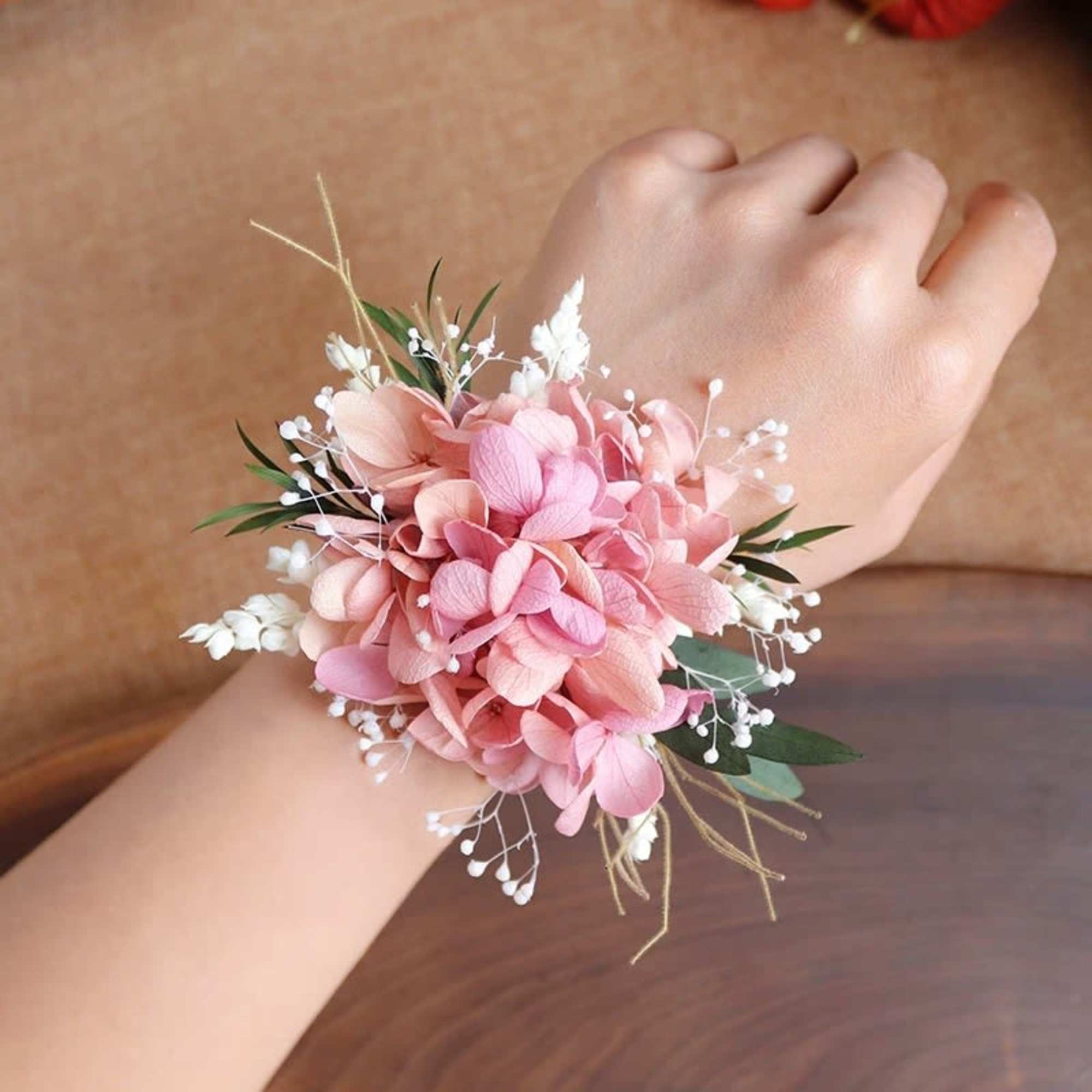 Pink floral wrist corsage with white filler flowers