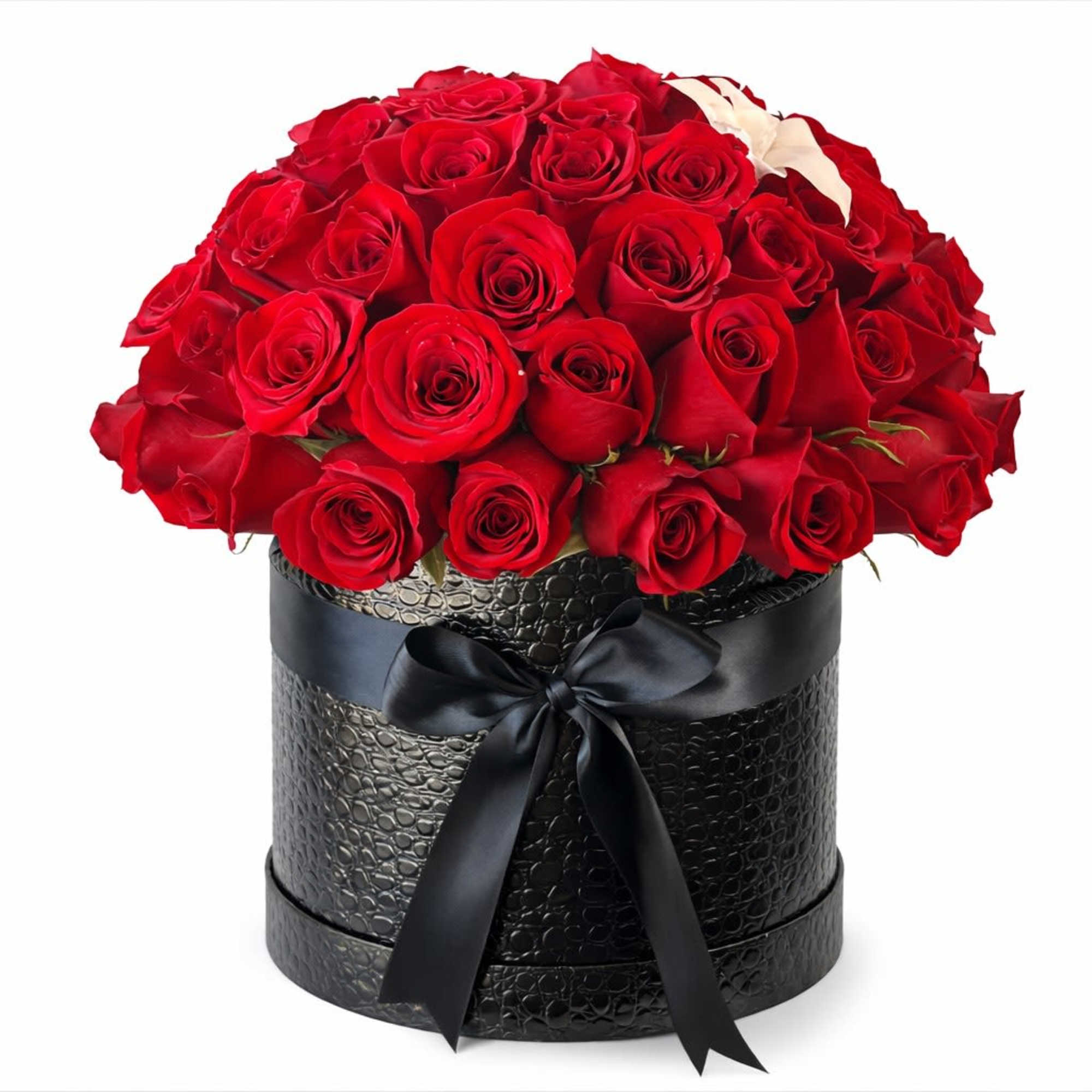 Round arrangement of red roses in a black hatbox with a black ribbon