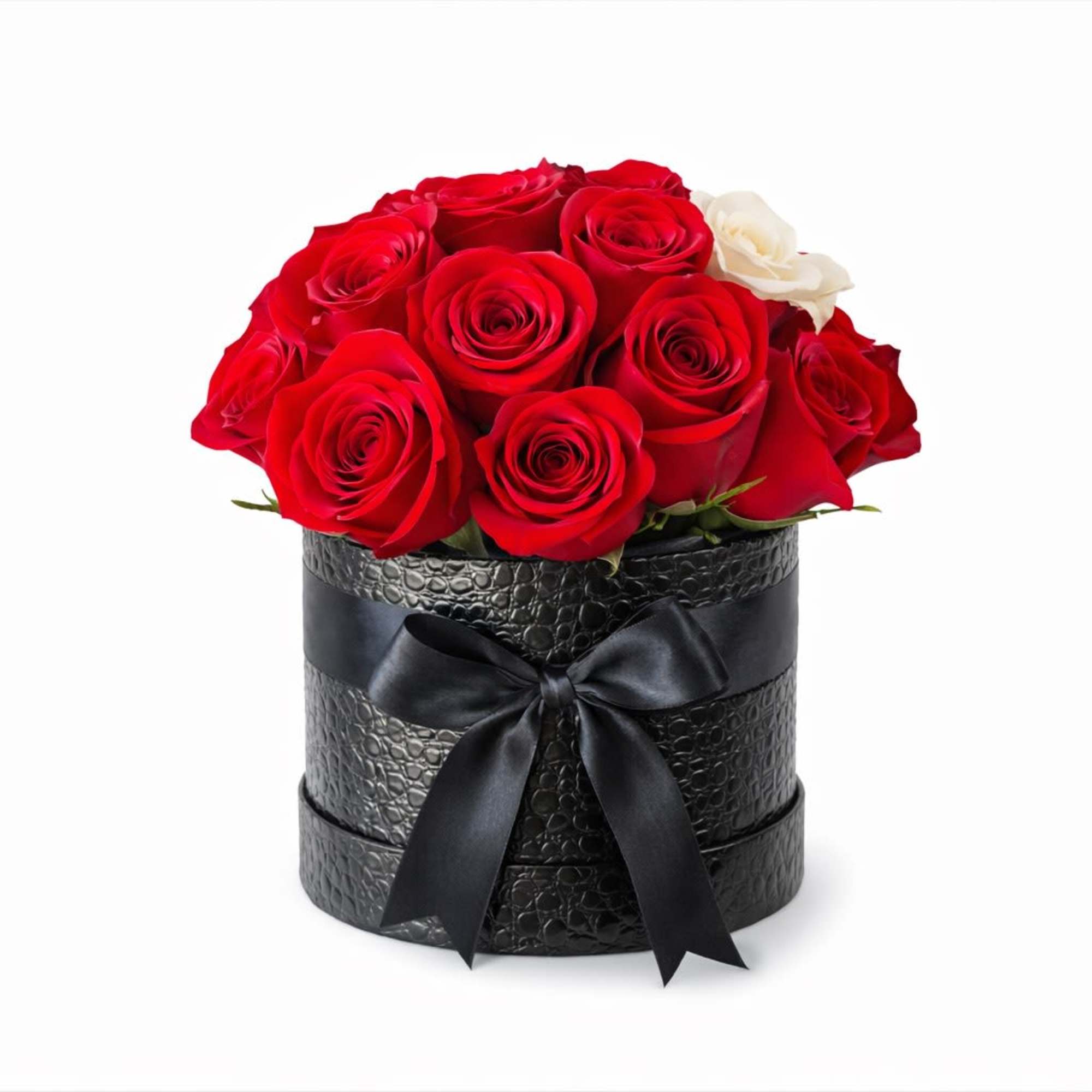 Red roses arranged in a black round box with a ribbon bow