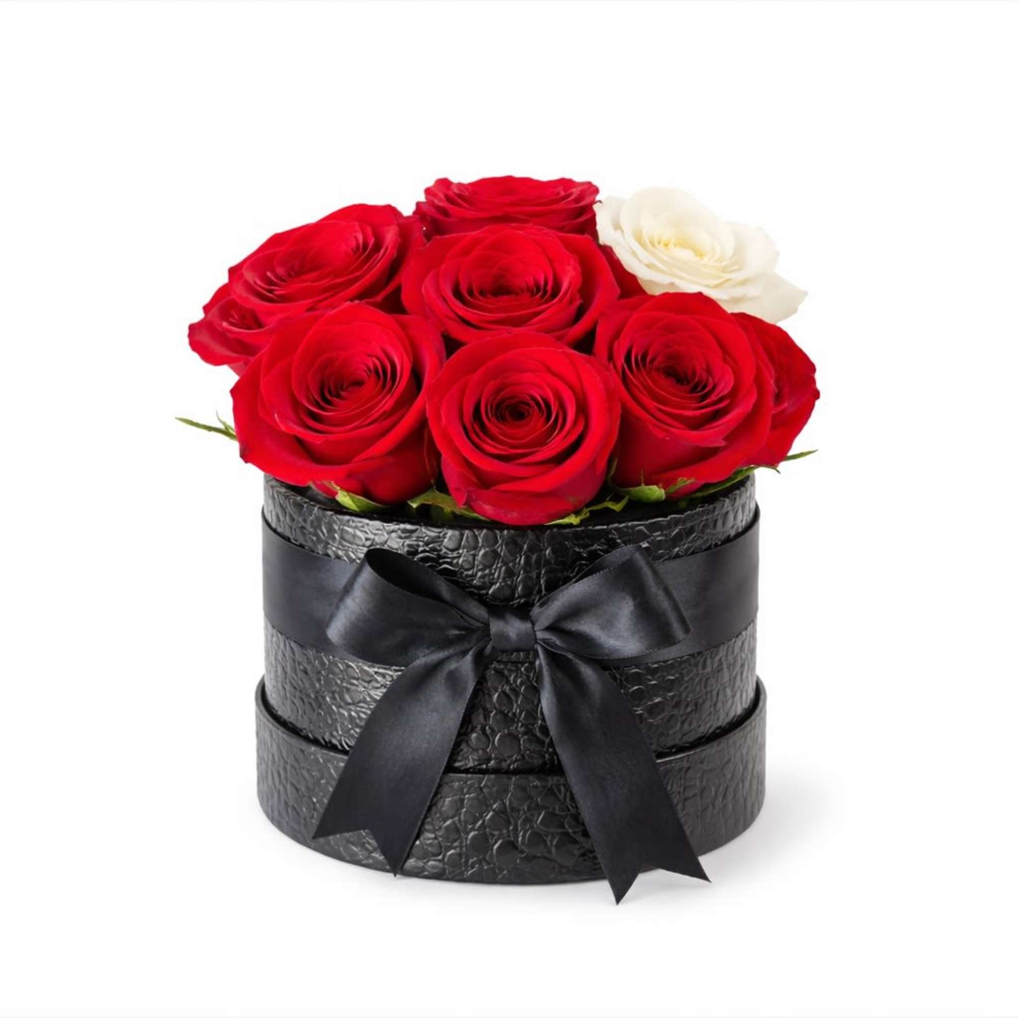 Red and white roses arranged in a black round box with a ribbon