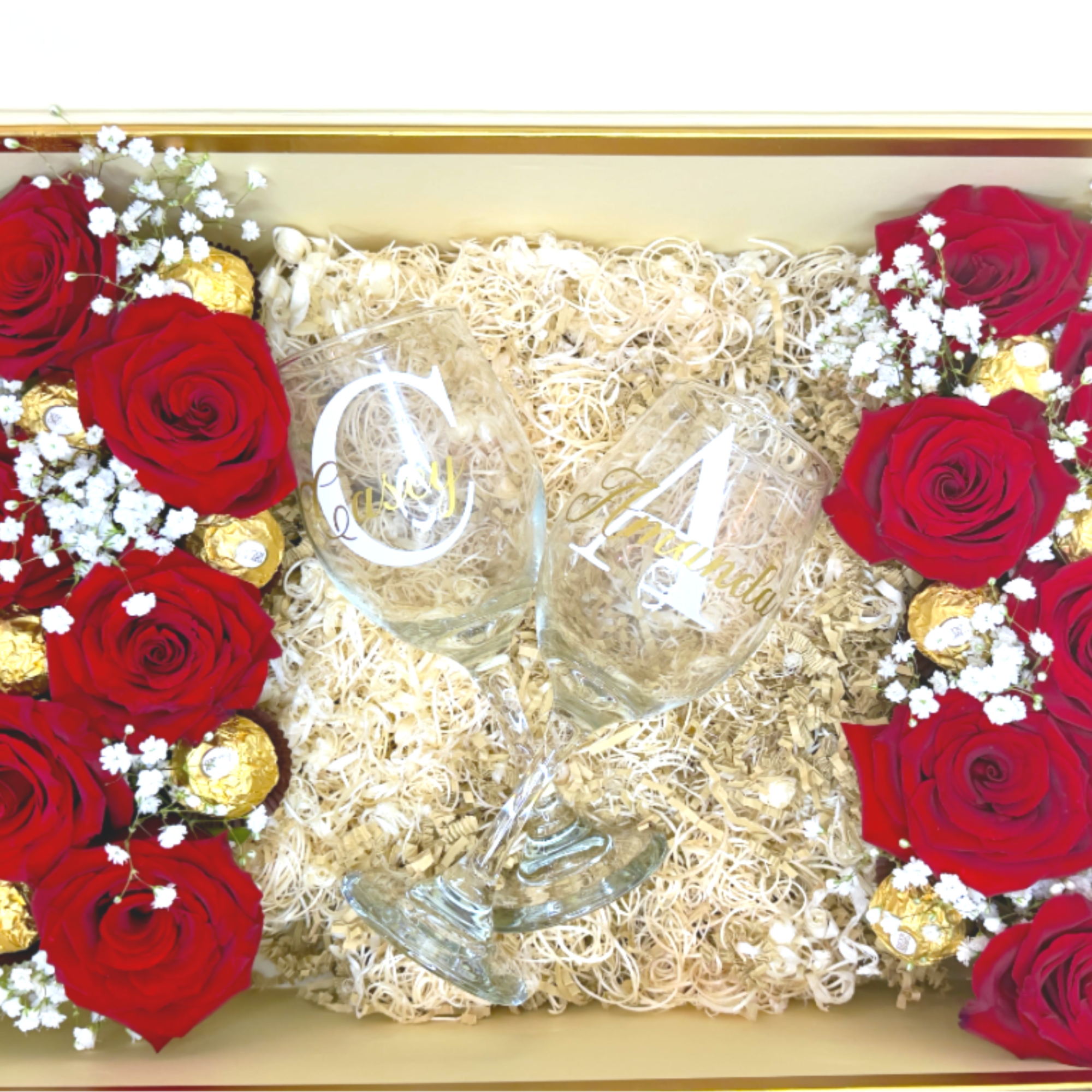 Gift box with red roses, baby’s breath, and two etched wine glasses