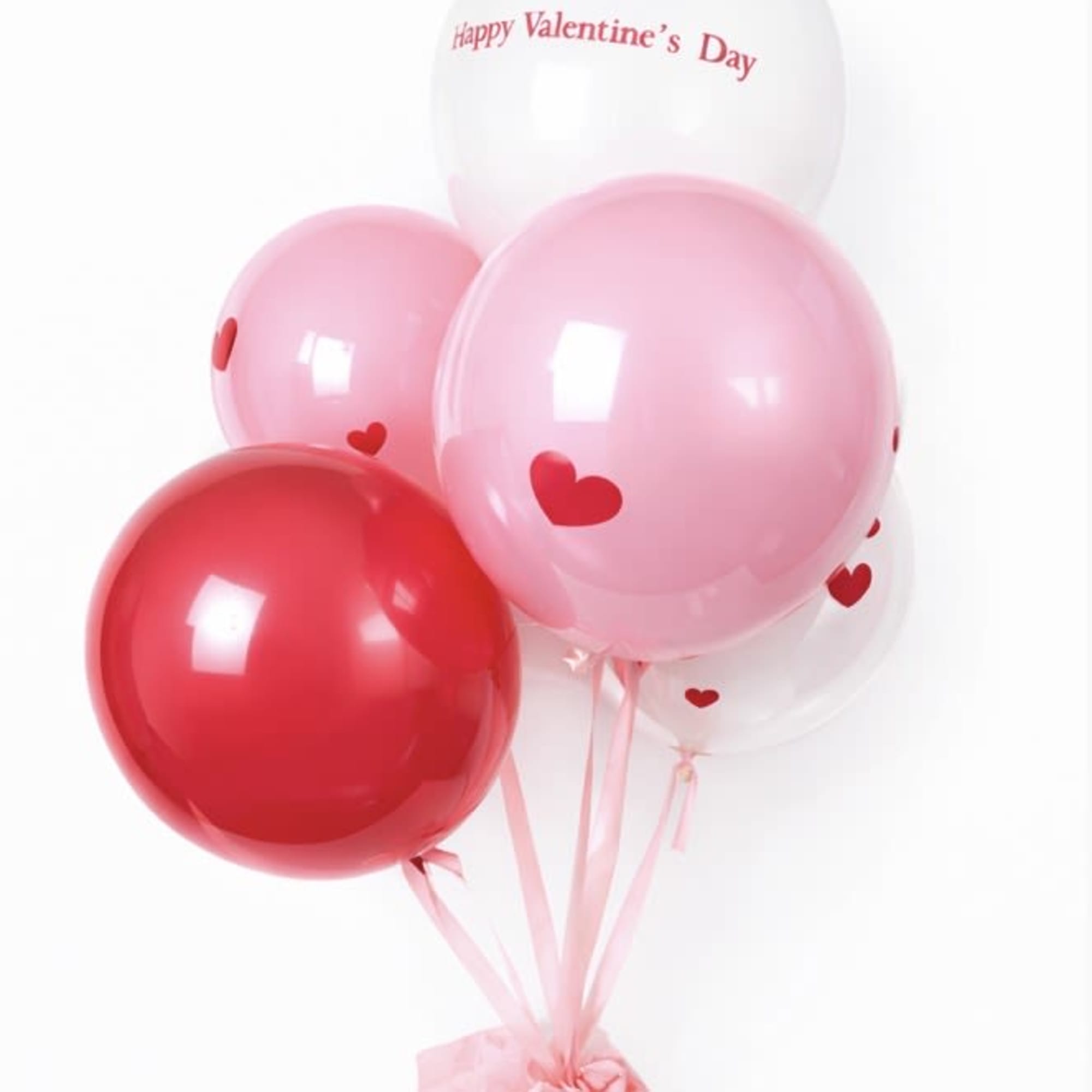 Cluster of pink, red, and white heart balloons with a Valentine’s Day message