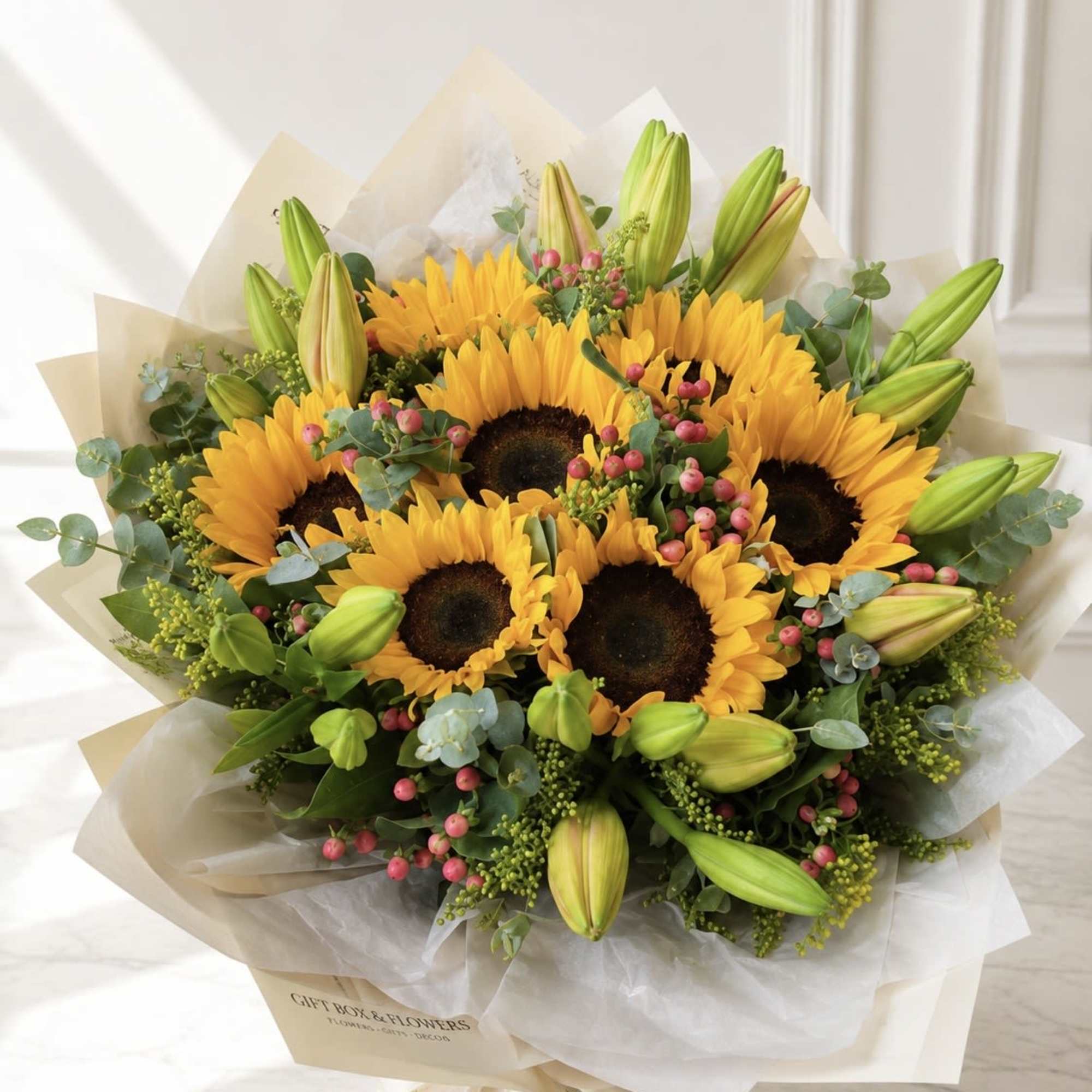 A stunning bouquet featuring 7 large sunflowers with dark centers and vibrant