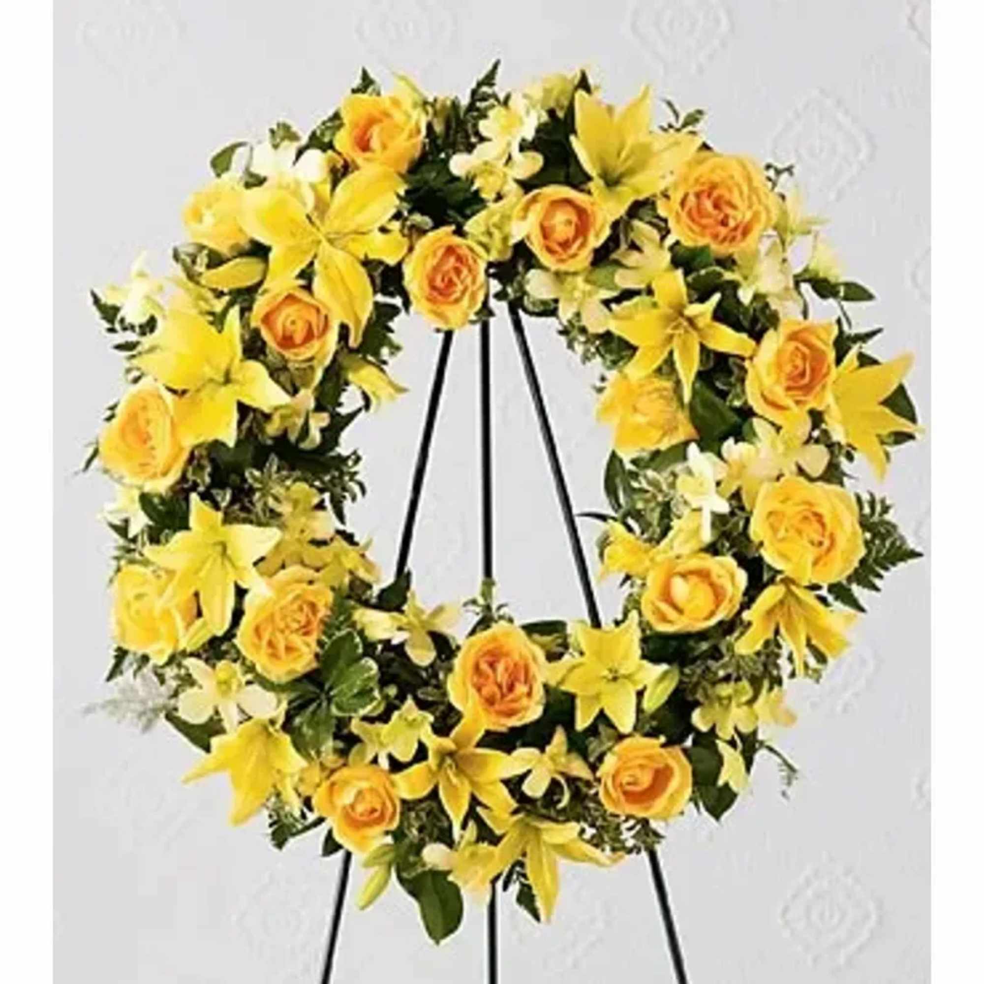 This beautiful wreath holds golden yellow roses, Asiatic lilies and dendrobium orchids