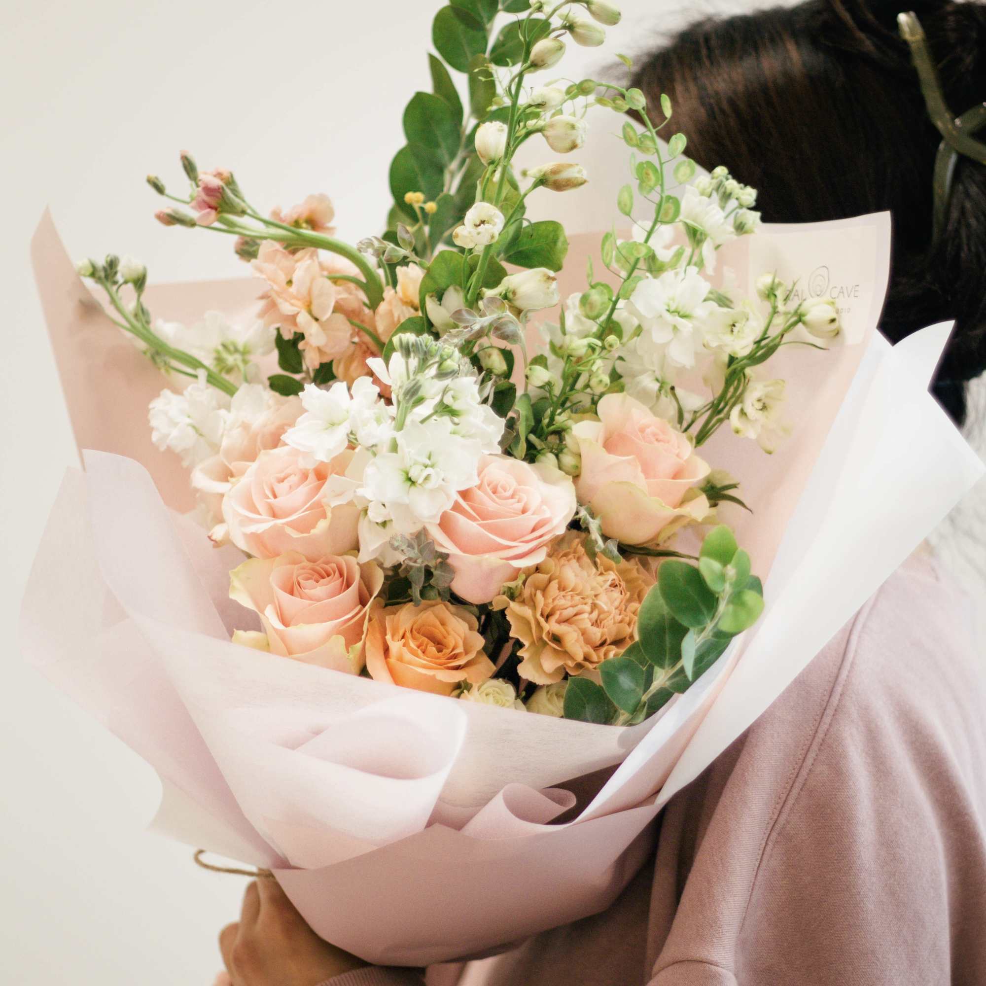 Bouquet of peach and white roses with white filler flowers