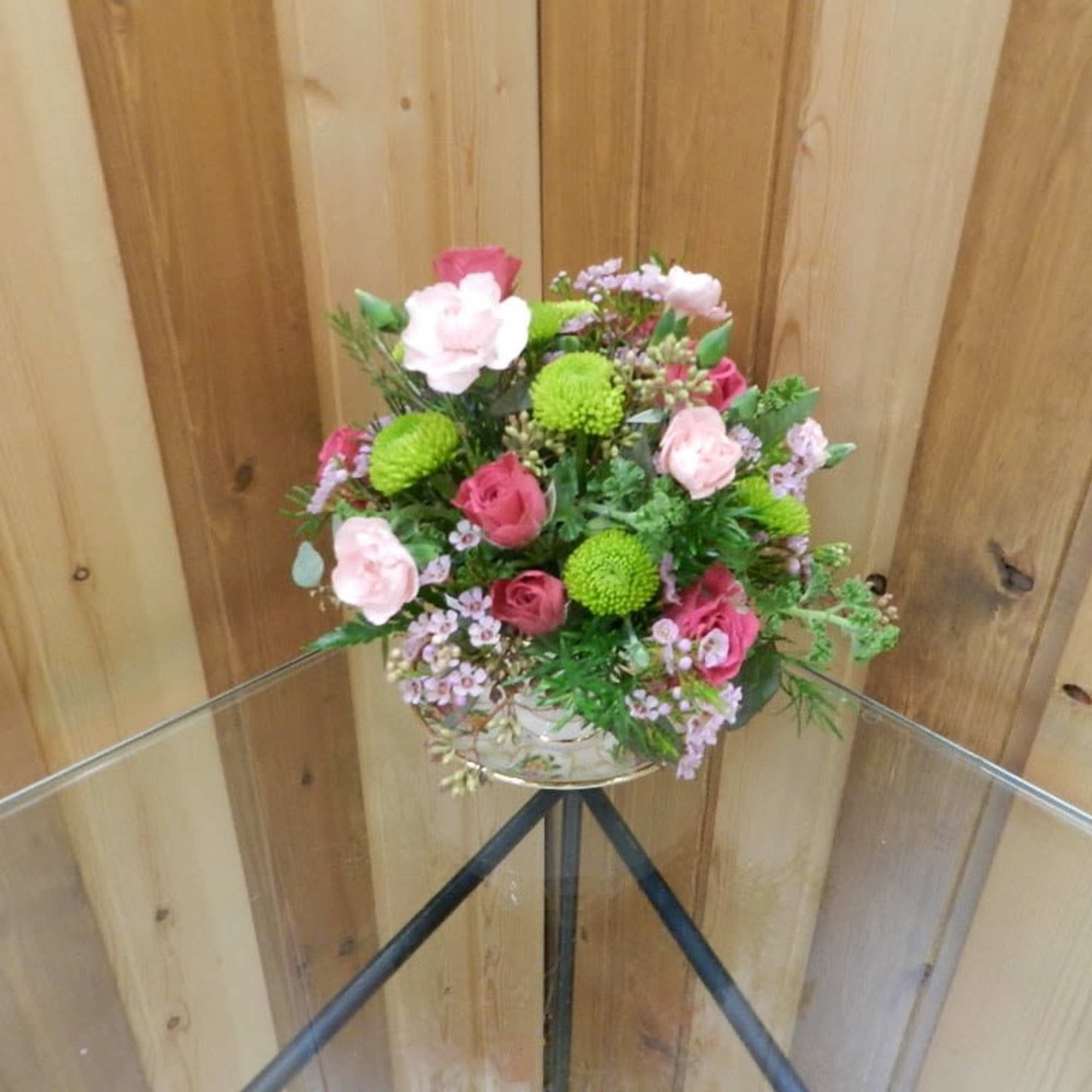 Pink and green mixed flower arrangement in a clear glass vase