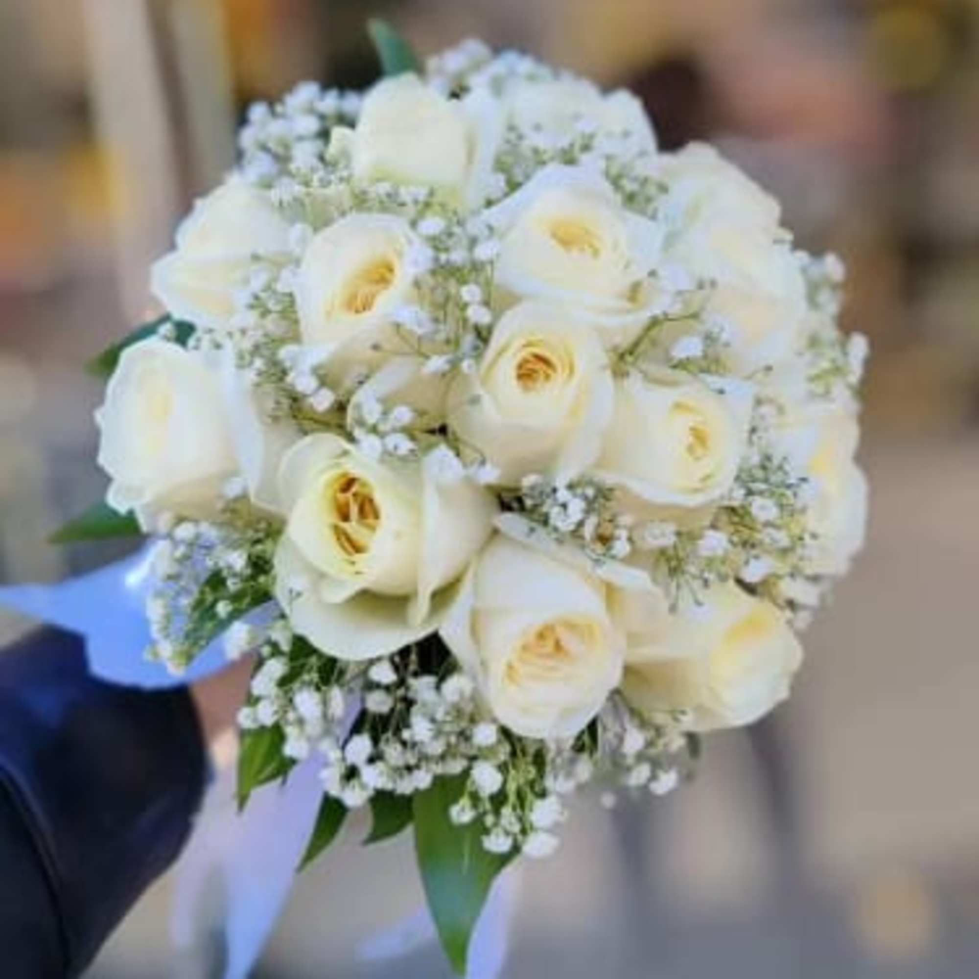 White rose bridal bouquet with baby's breath and ribbon