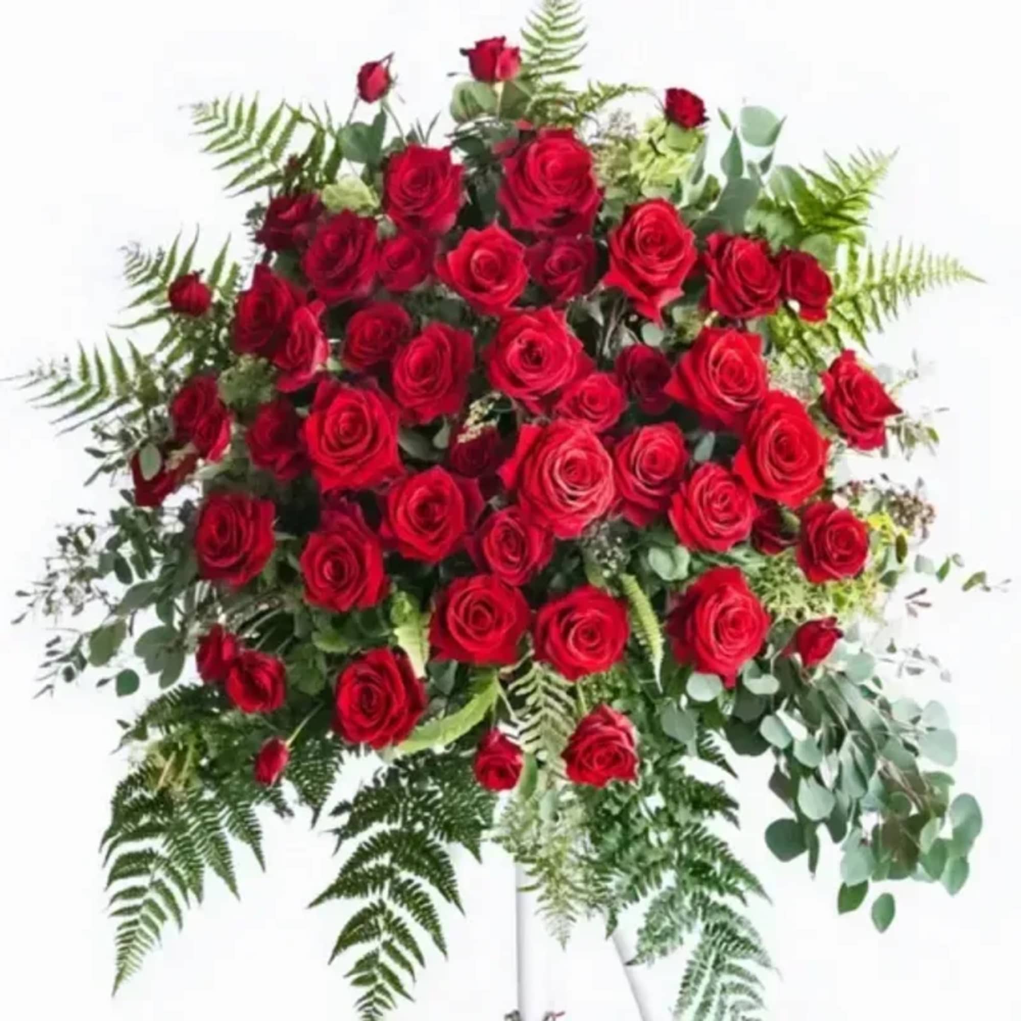 A dense, rounded spray of deep red roses designed to make the