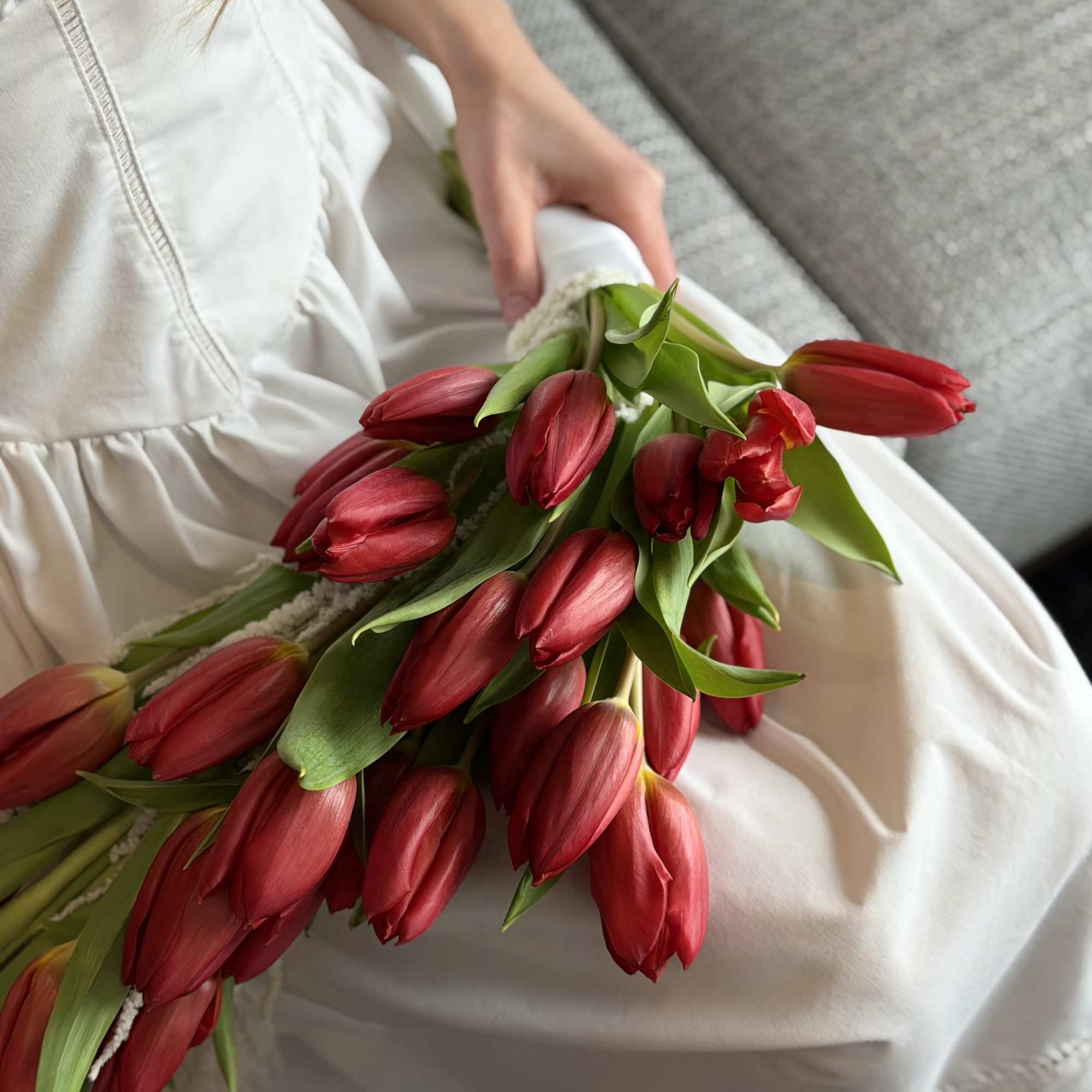 A dramatic cascade of deep red tulips-this bridal bouquet brings bold romance