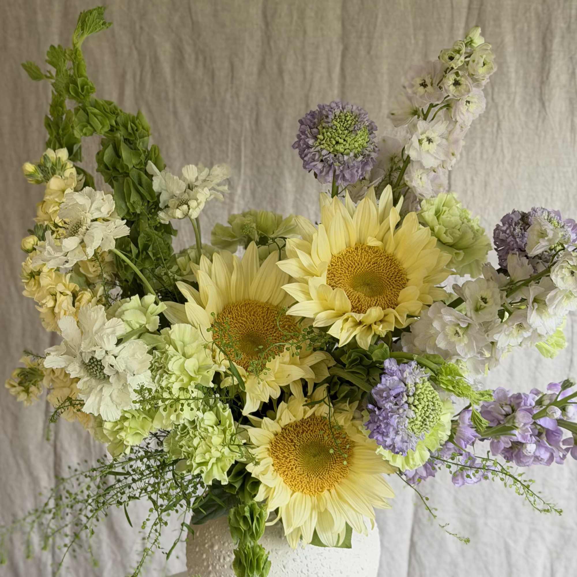 Sunflowers take center stage in this Sweet Summer flower arrangement, a cheerful