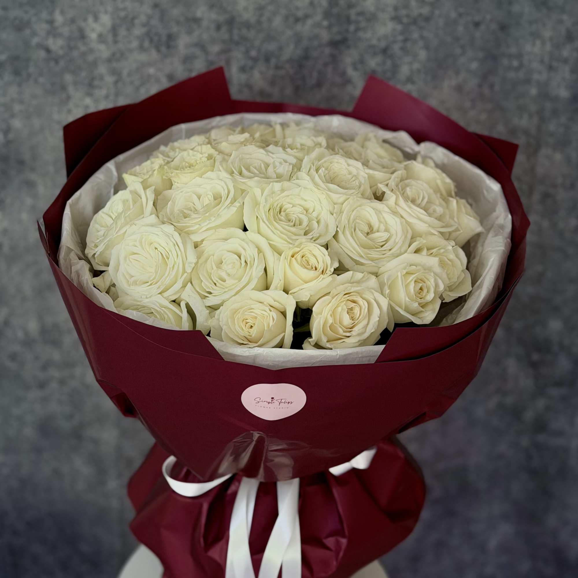 A lush cloud of cream-white roses makes an immediate, elegant impression-perfect as