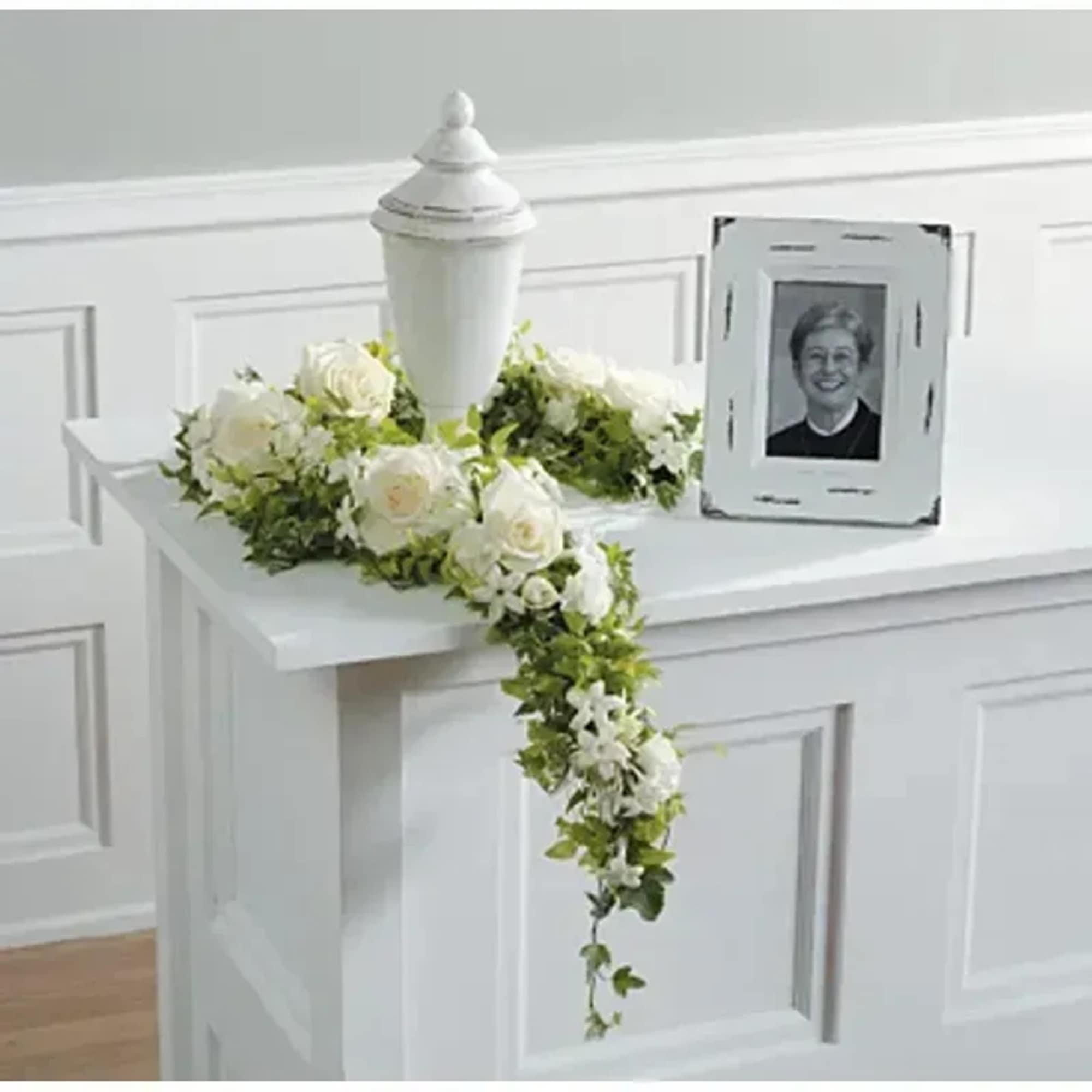 A garland of all white blooms to soften a memorial urn.
