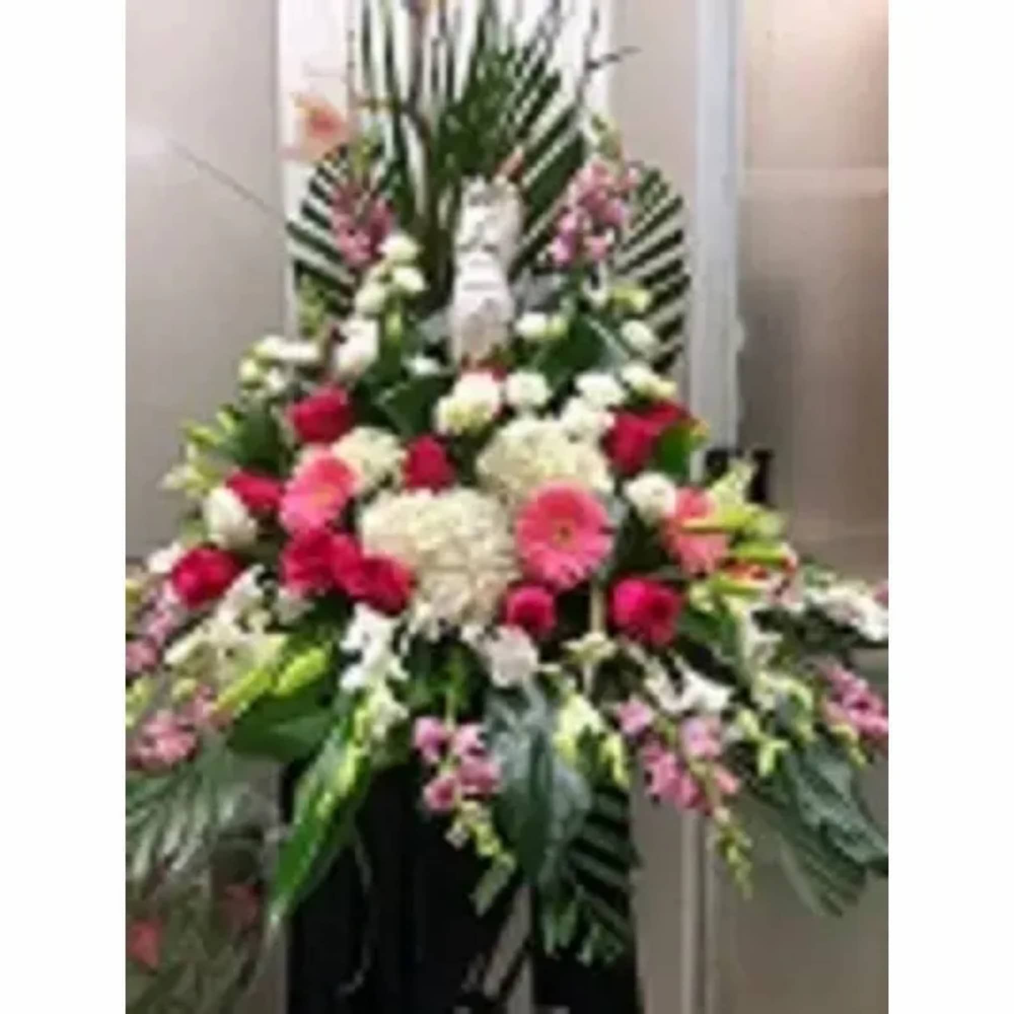 Lovely Angel tribute display of flowers for your loved ones.
