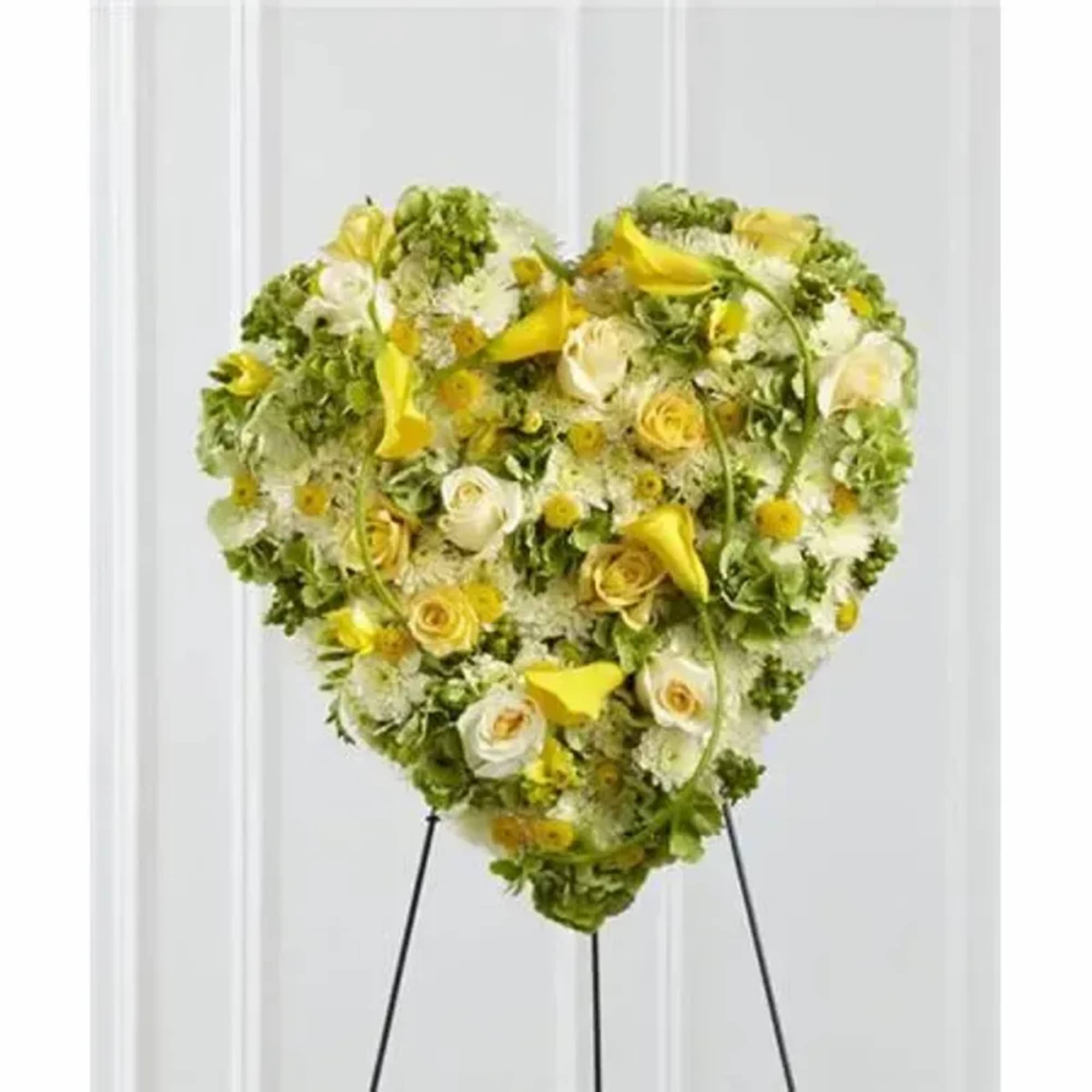 A collection of sunlit blooms, including, yellow roses, freesia, mini calla lilies