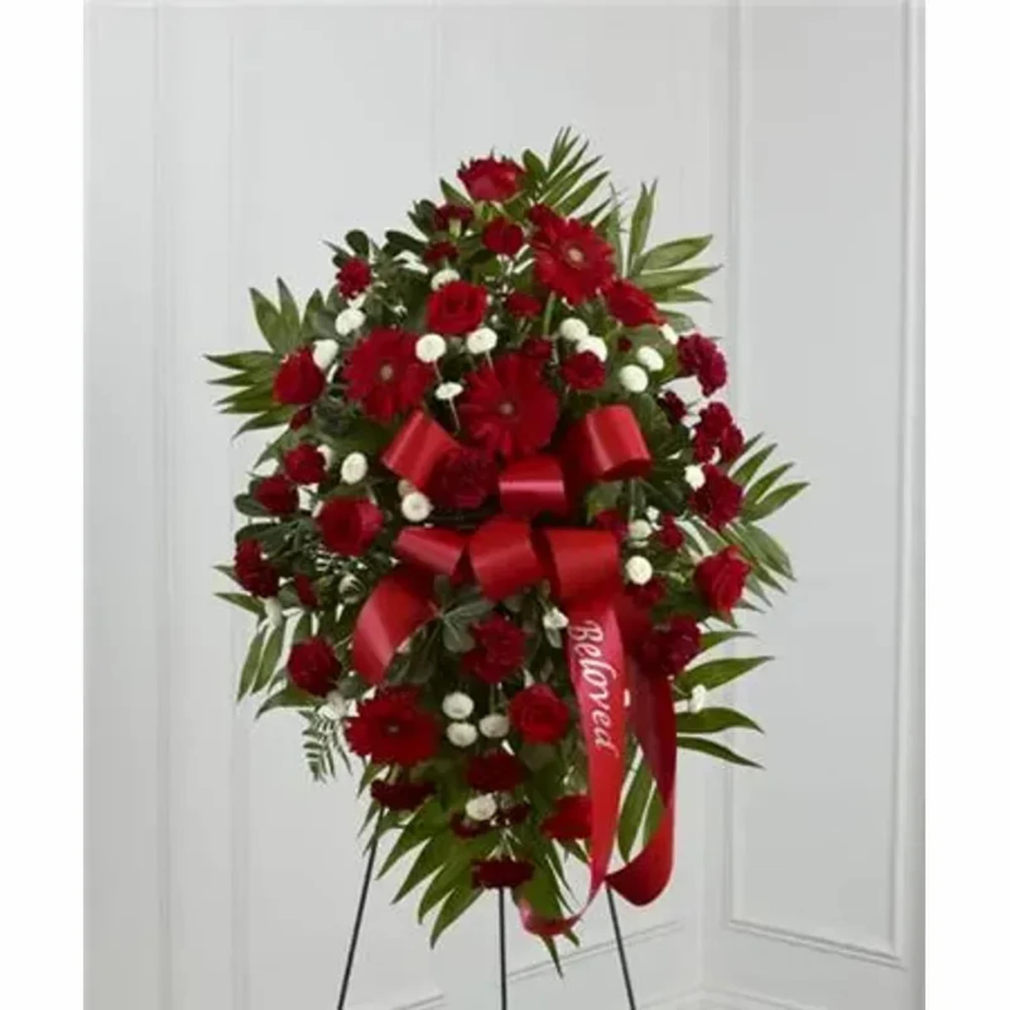An exceptional arrangement of red roses, burgundy carnations, burgundy mini carnations, red