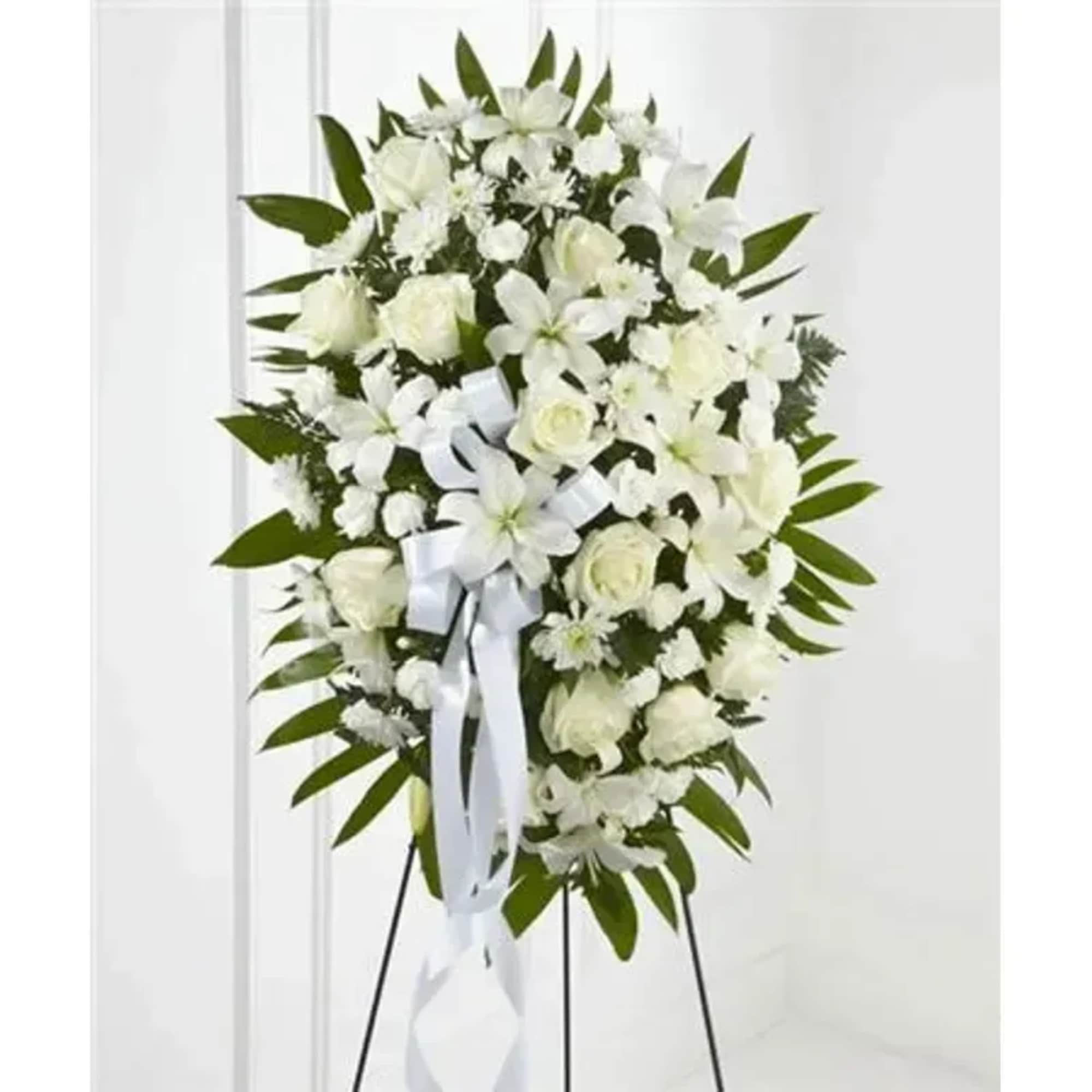 White roses, Asiatic lilies, chrysanthemums and mini carnations are artfully arranged amongst