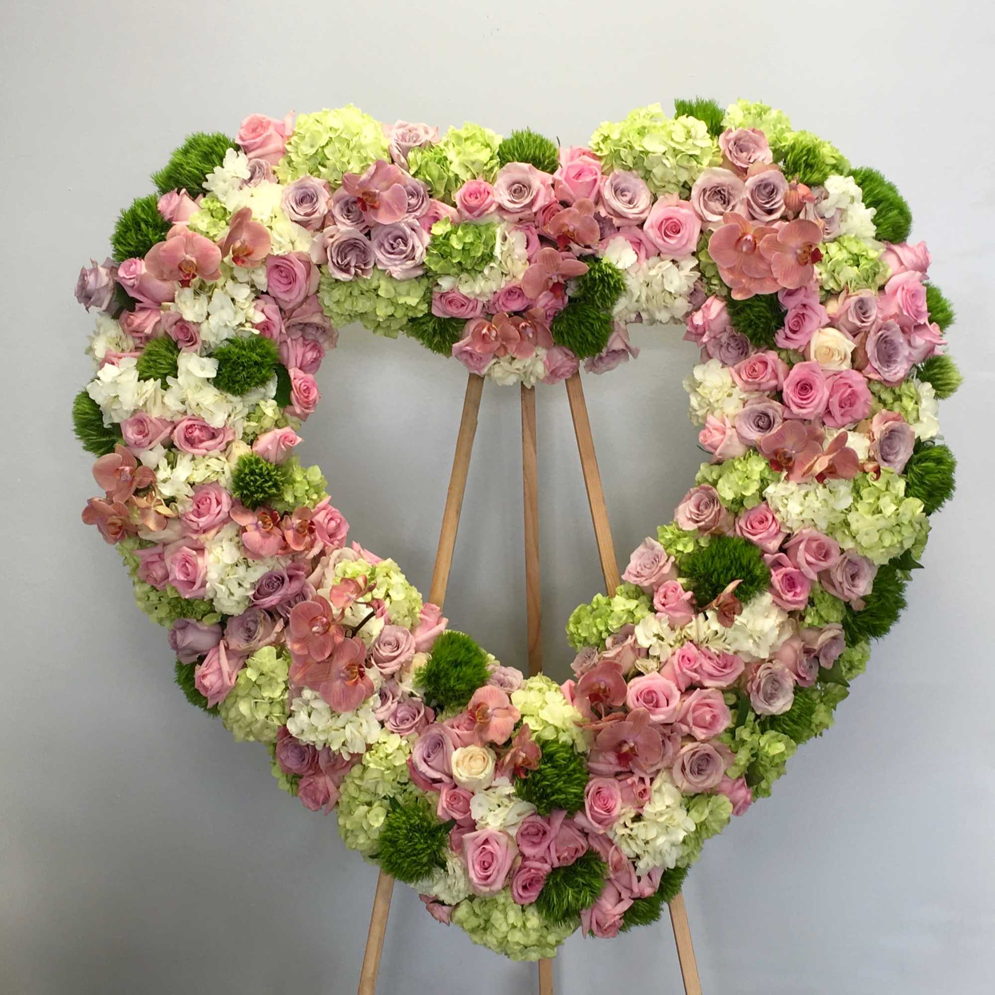 This heart is made with green, white, and pink florals.

We include easel