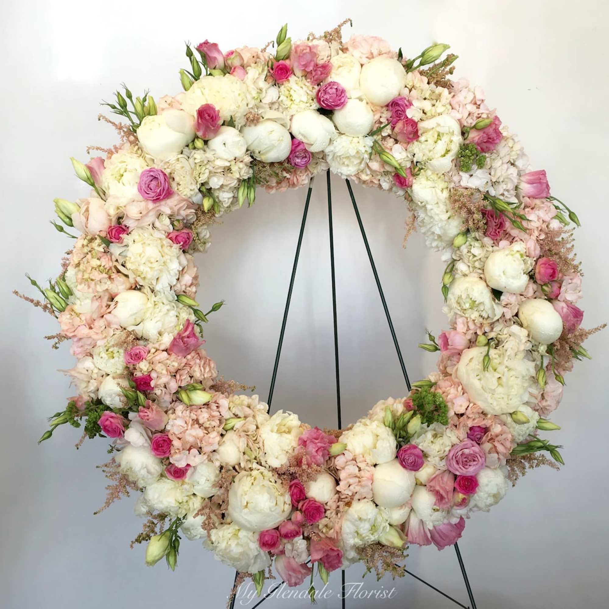 Peonies, Garden roses, orchids, hydrangeas, roses, &amp; lisianthus on a wreath.

We include