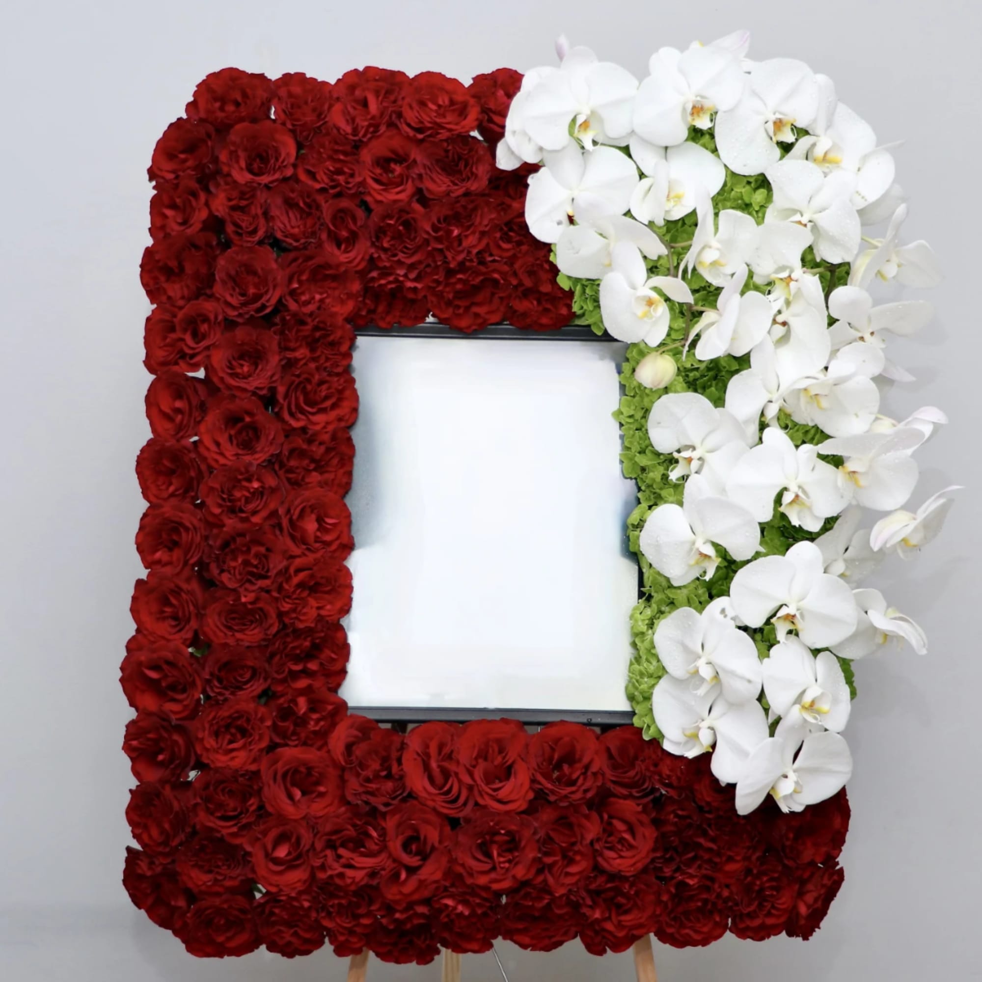 Rectangular floral frame with red roses and white orchids around a blank center