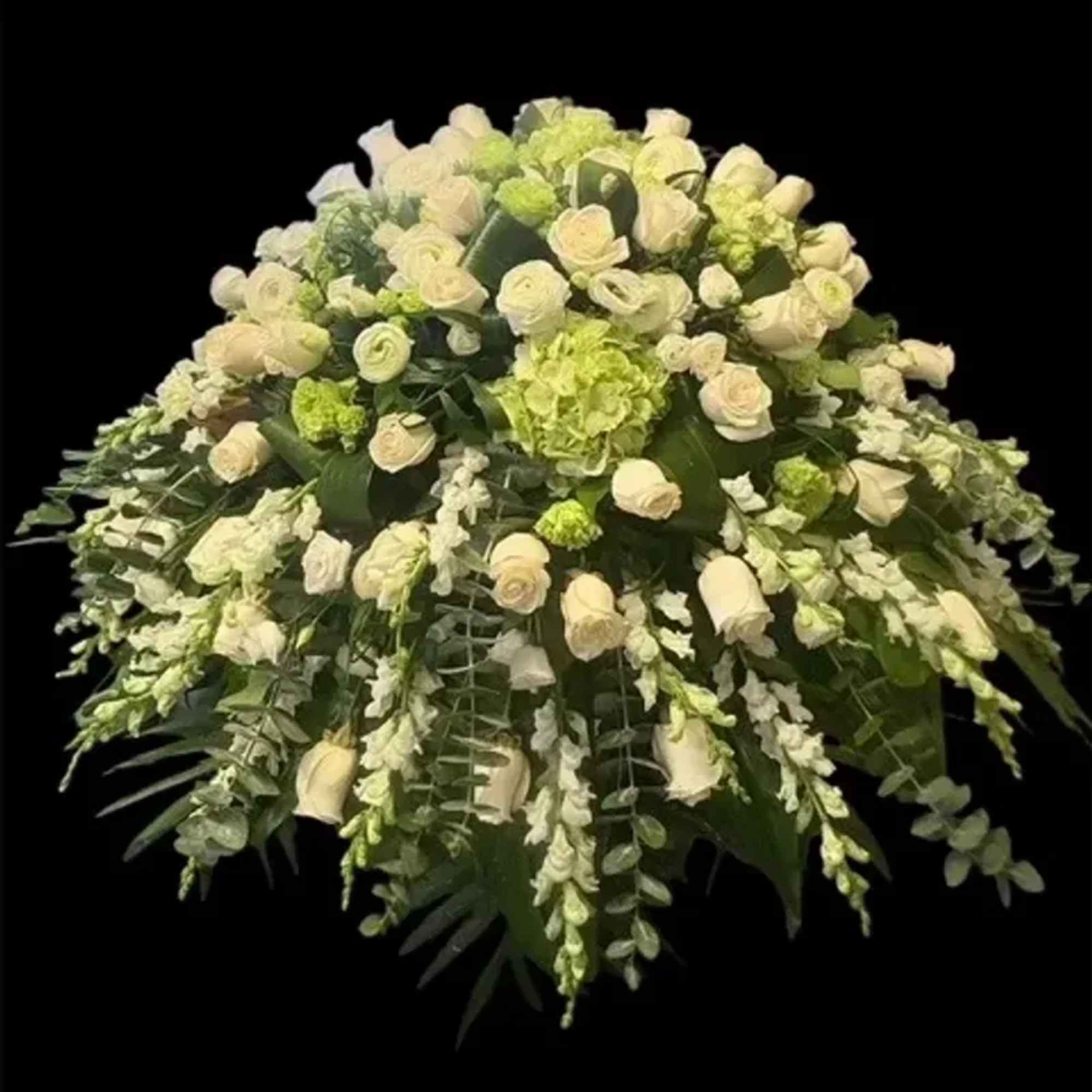 A large, rounded spray of cream-white roses and pale green blooms creates