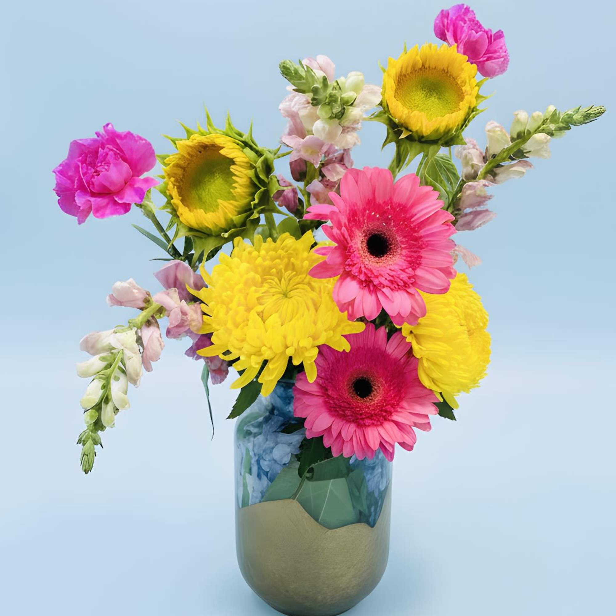 Hot pink gerbera daisies meet sunny yellow sunflowers and cheerful chrysanthemums 