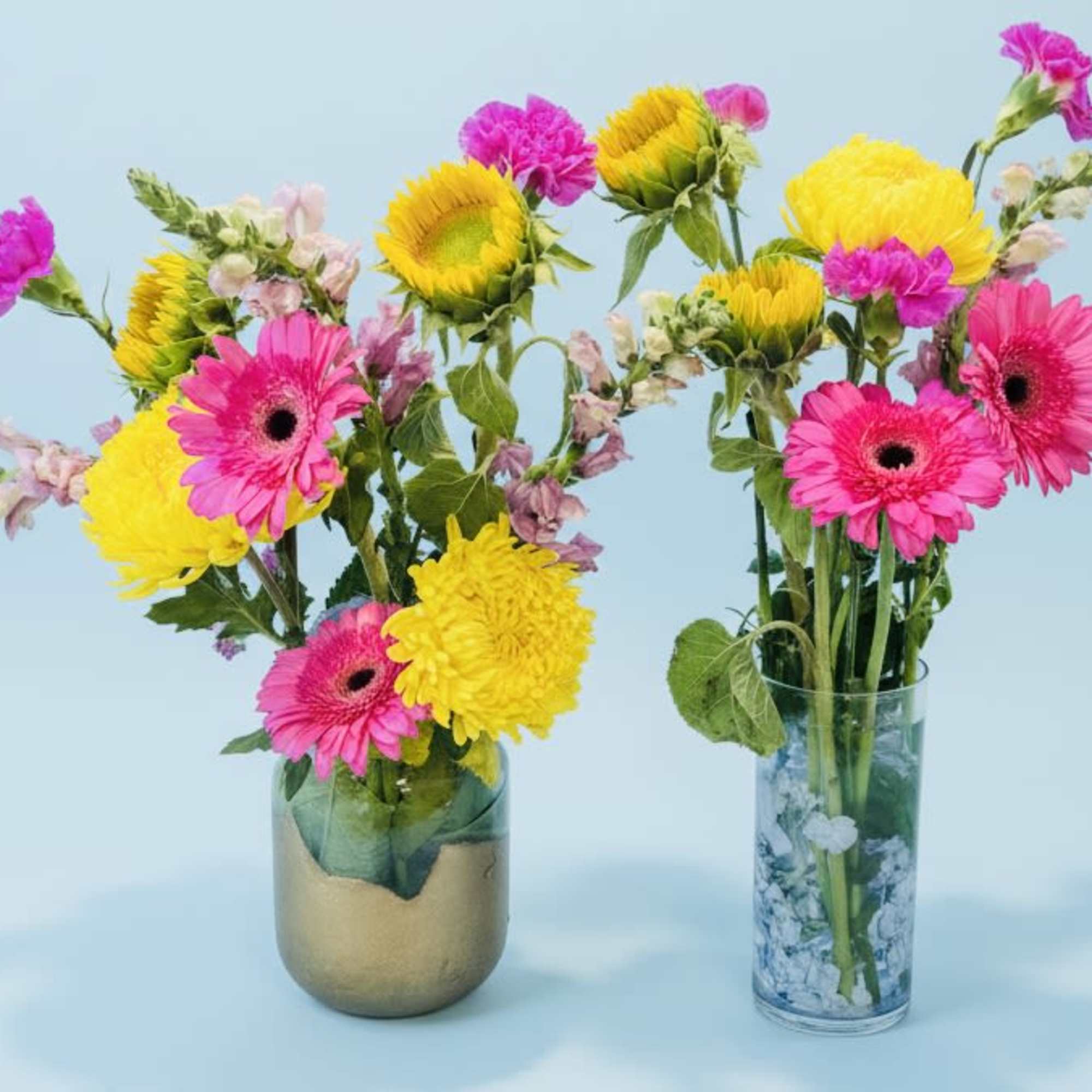 Hot pink gerbera daisies meet sunny yellow sunflowers and cheerful chrysanthemums 