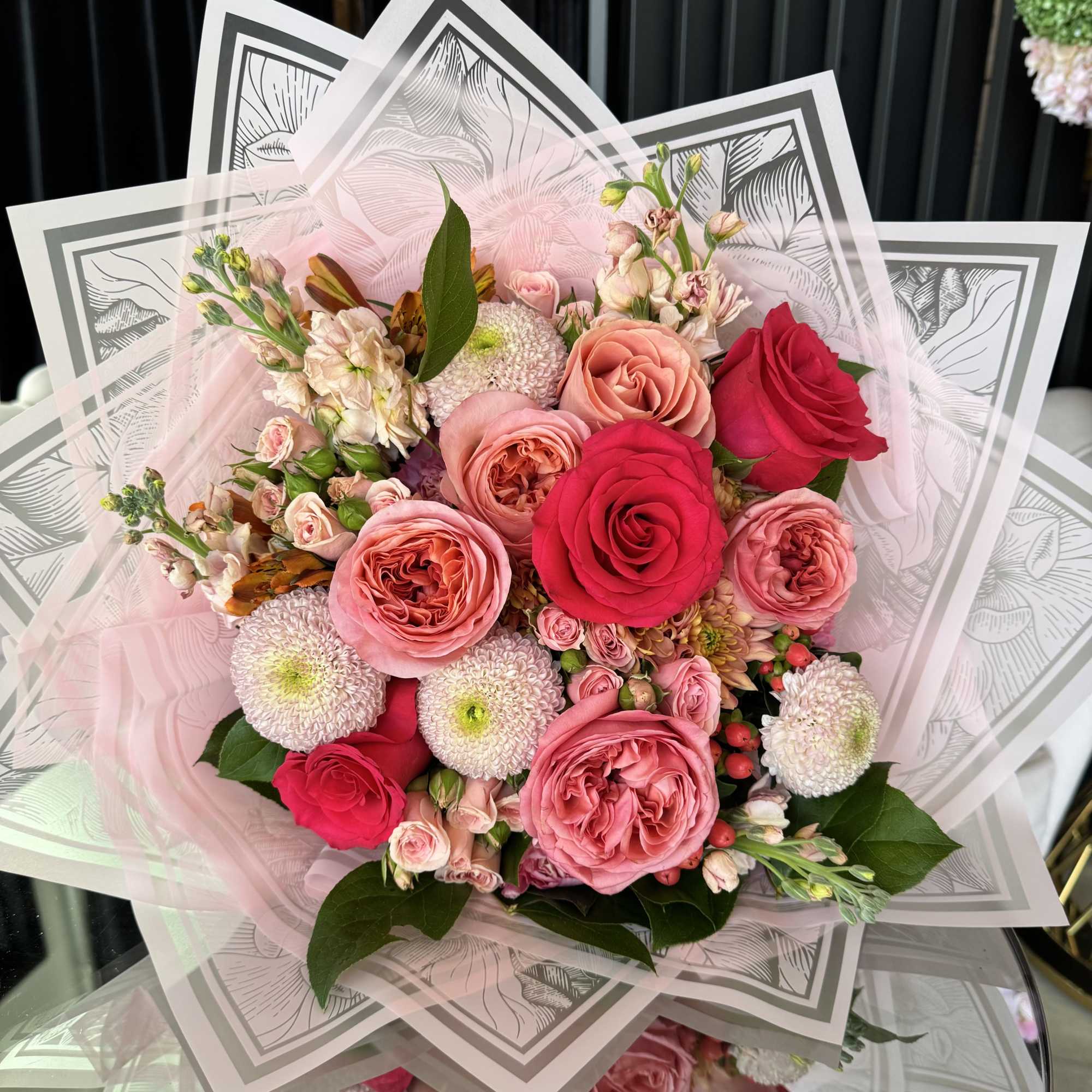 Indulge in a lush tapestry of pinks and deep berries. This hand-tied