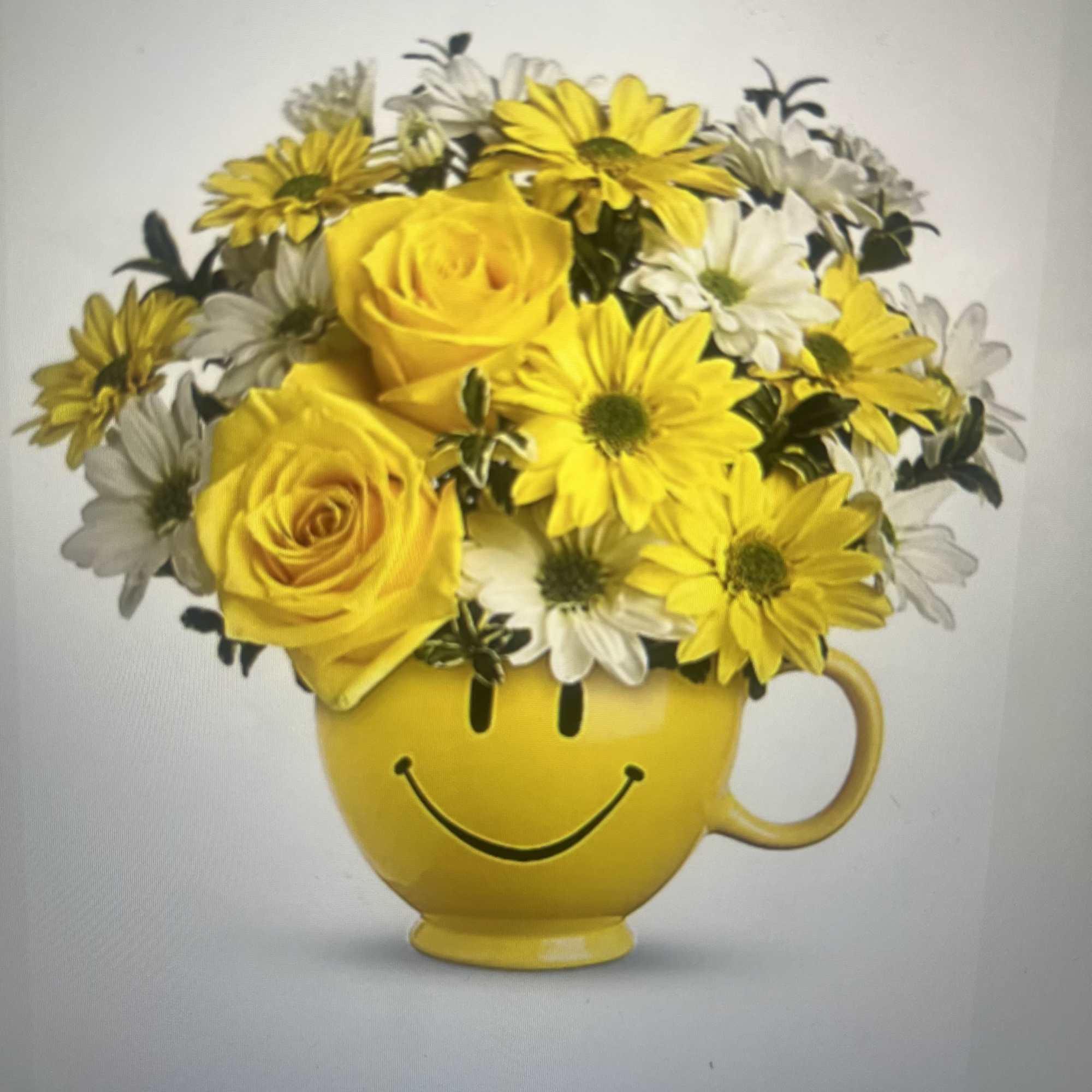 Sunshine in a mug - bright yellow roses and cheerful white-and-yellow daisies