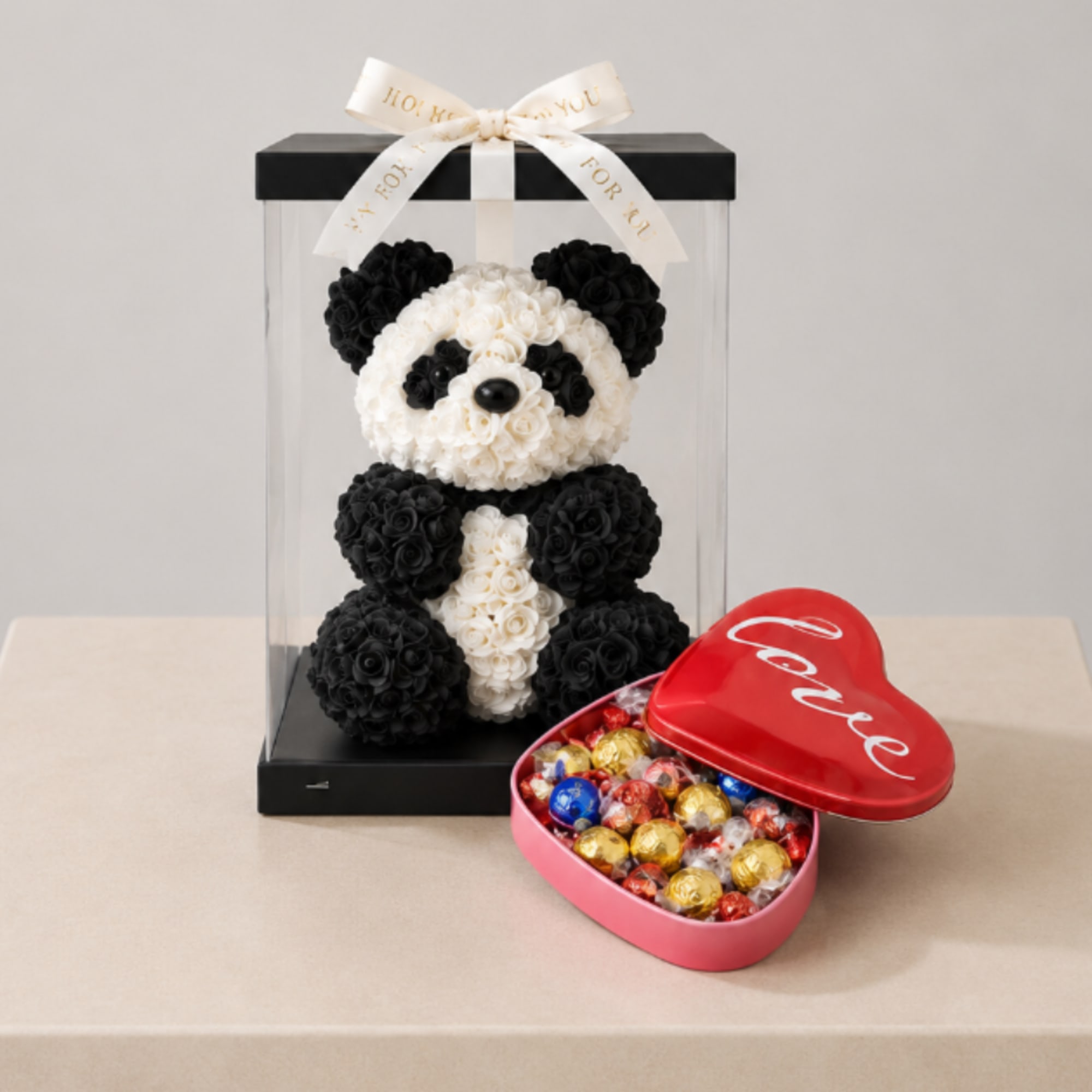 A beautiful gift set featuring a handcrafted rose panda in a clear