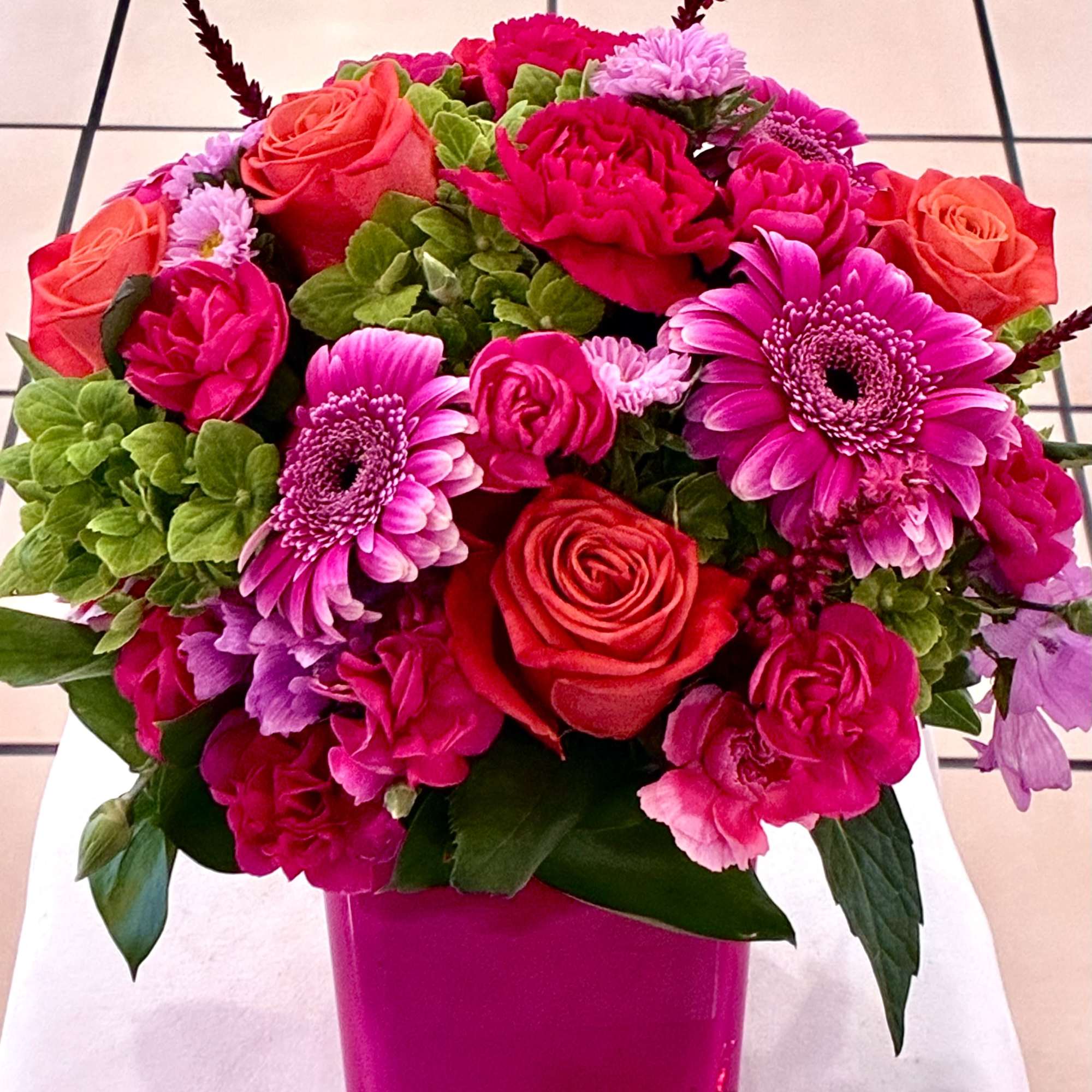 Hot Pink arrangement in a short cube vase. makes this arrangement look
