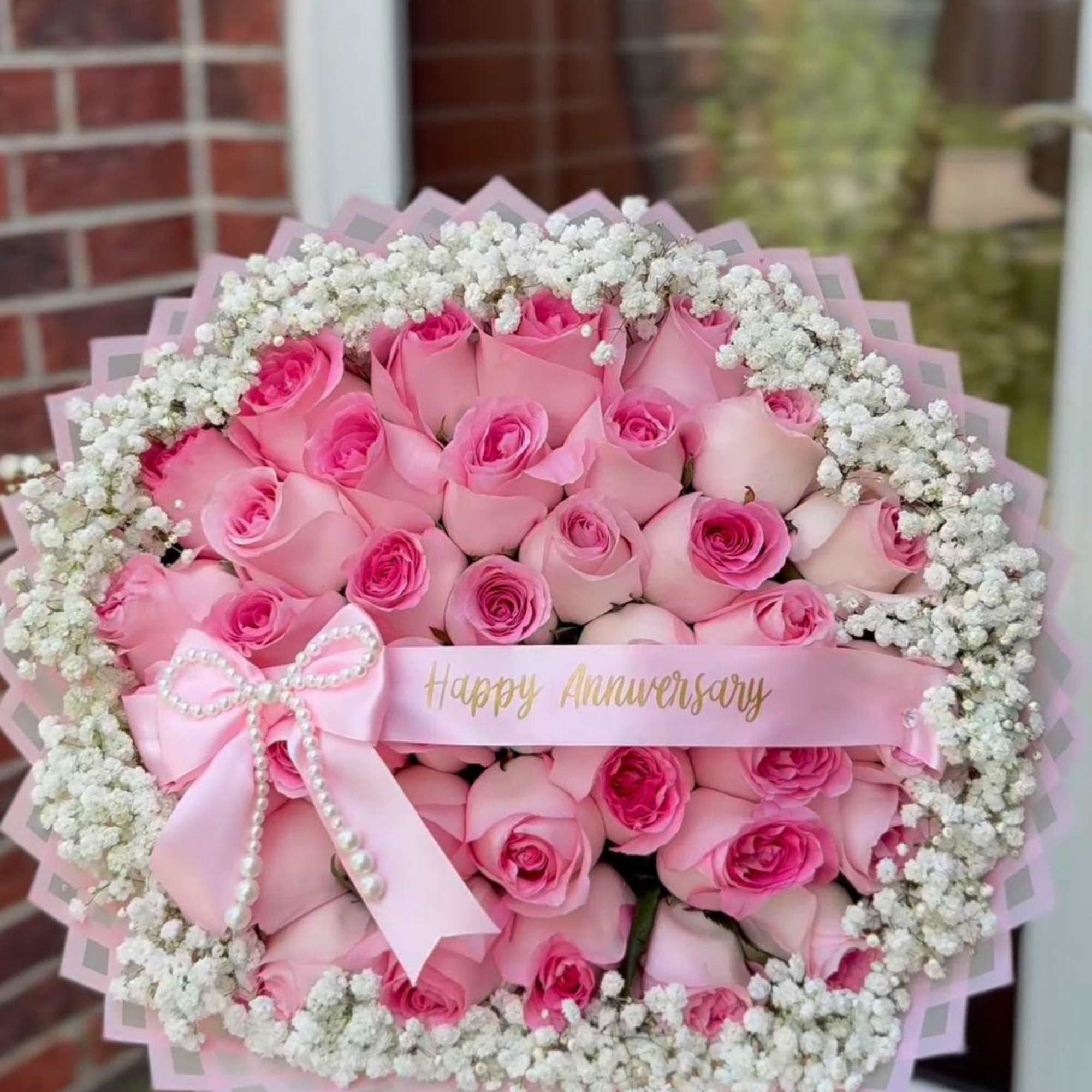 A lush dome of roses dressed for celebration-this flower arrangement is a
