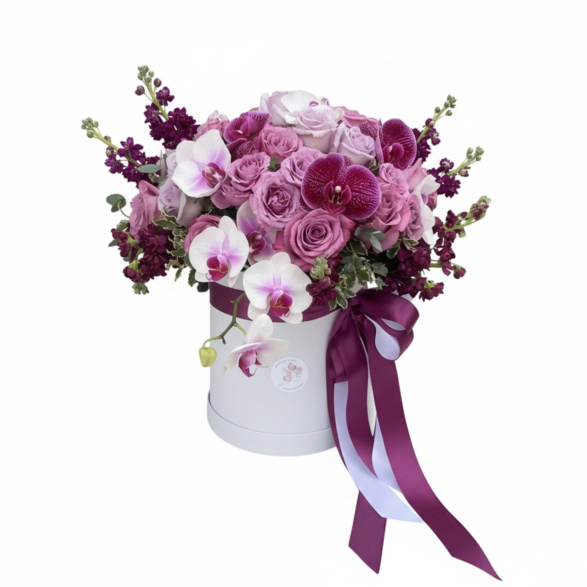 Deep, velvety purple roses and soft lavender spray roses mingle with exotic