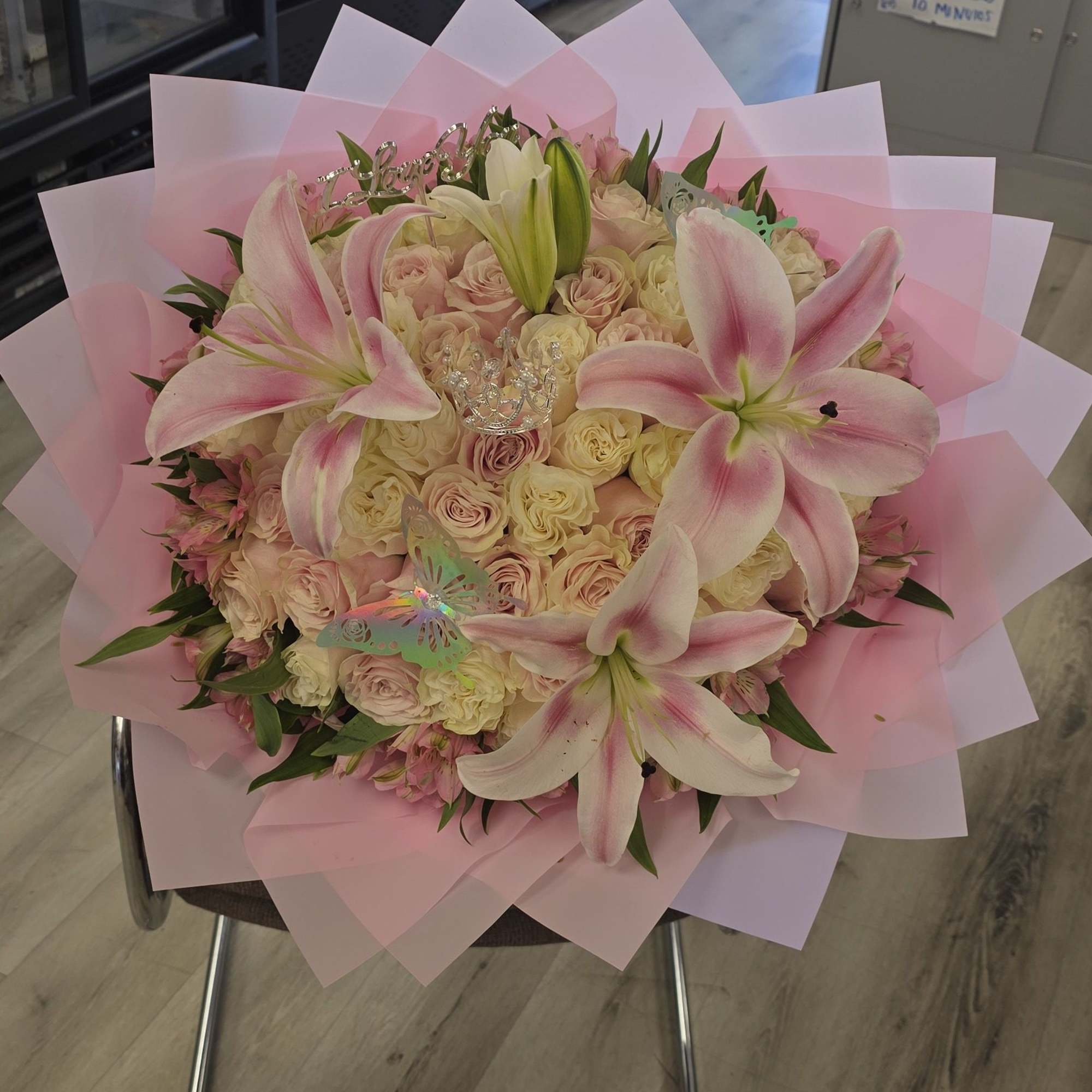 Soft pink lilies rising above a cloud of pale pink and cream