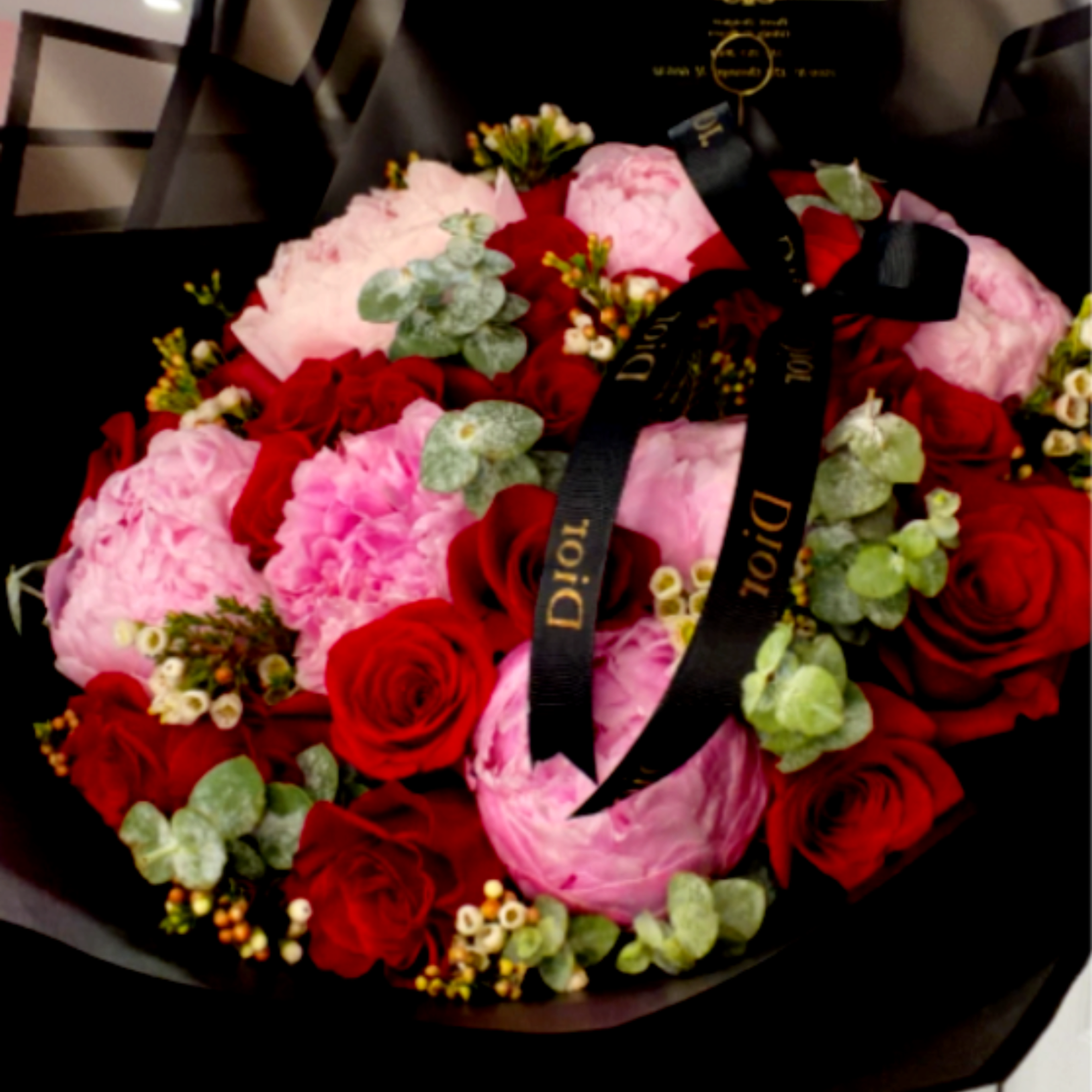 This luxurious arrangement features 24 premium long-stem red roses (70 cm), carefully