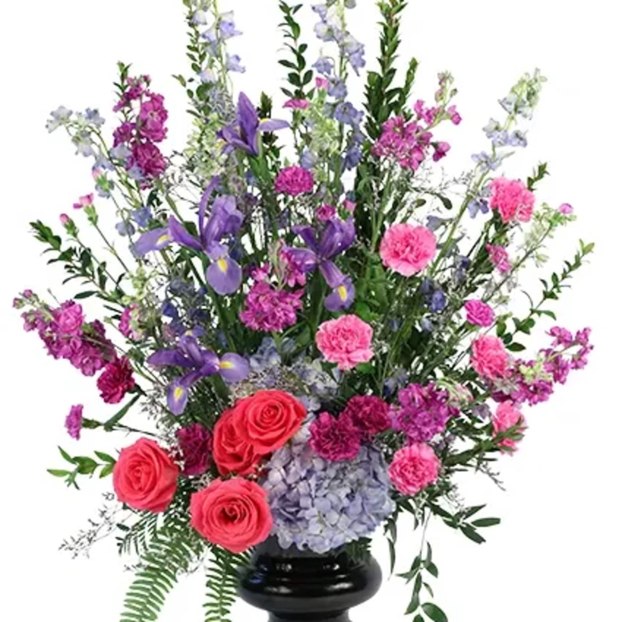 Remember the happy times of your loved one with this lovely arrangement.